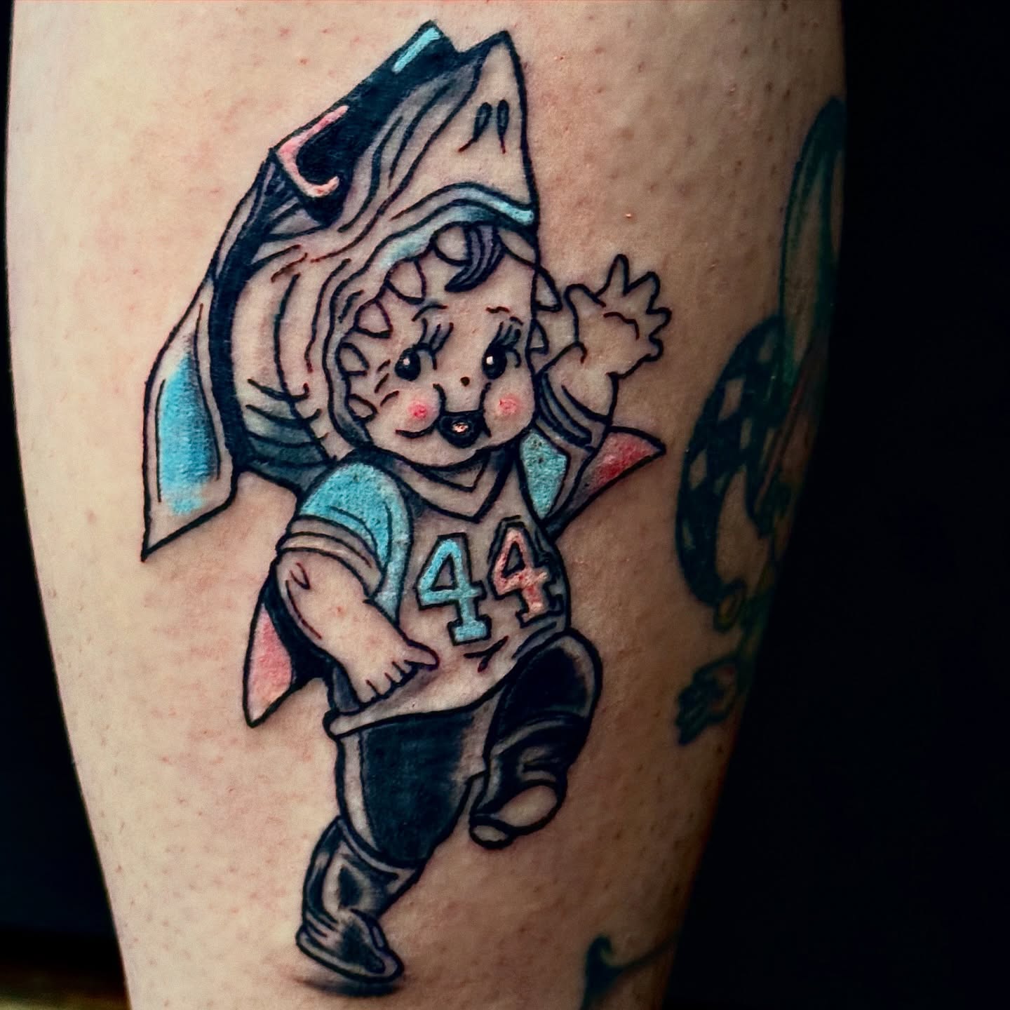 Football player shark American traditional tattoo on the forearm by Evan Intveld