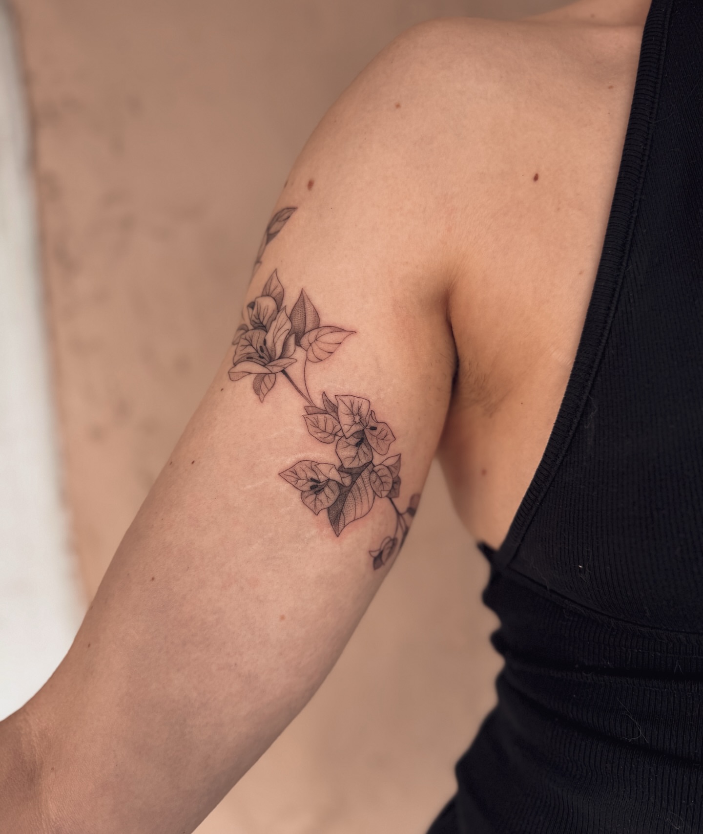 Flowers black and grey tattoo on the forearm by Floral