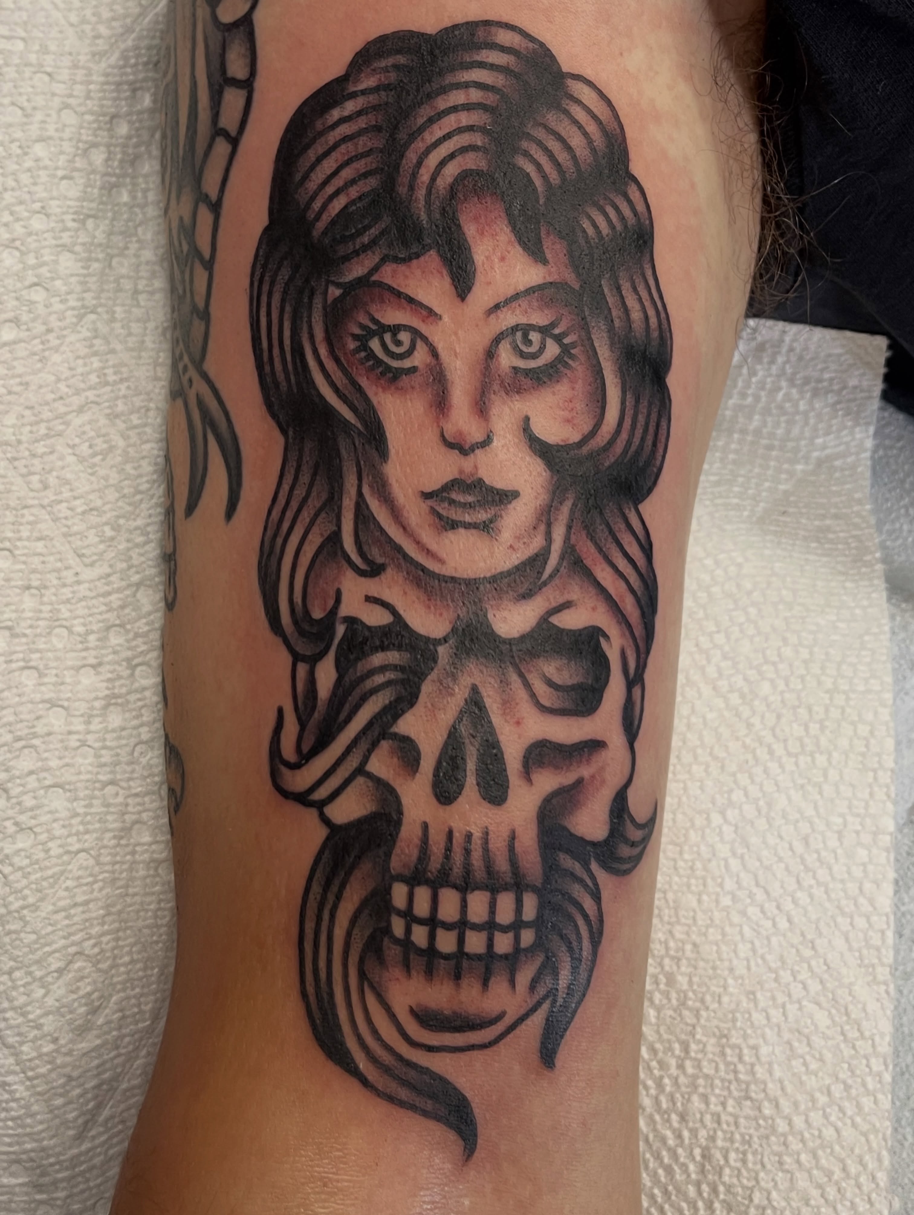 Woman with skull realism tattoo on the forearm by Chris Martin