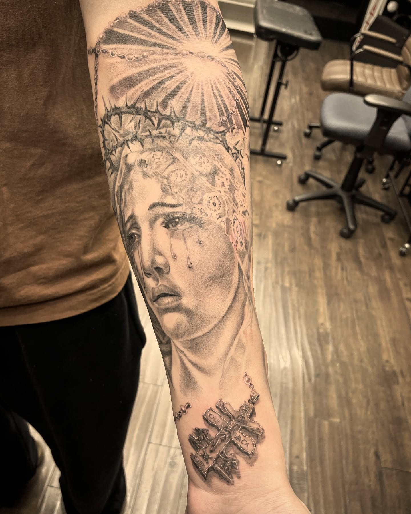 Religious figure realism tattoo on the forearm by Chato