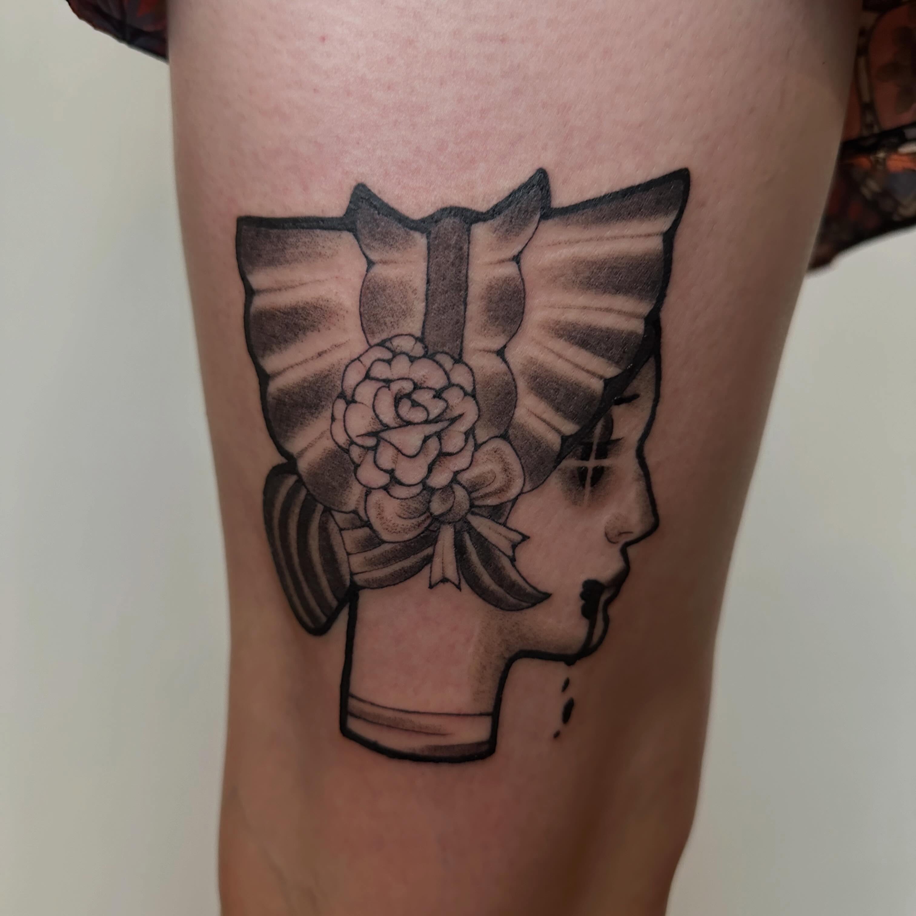Profile of a woman black and grey tattoo on the thigh by Nia Malone (Knee-Uh)