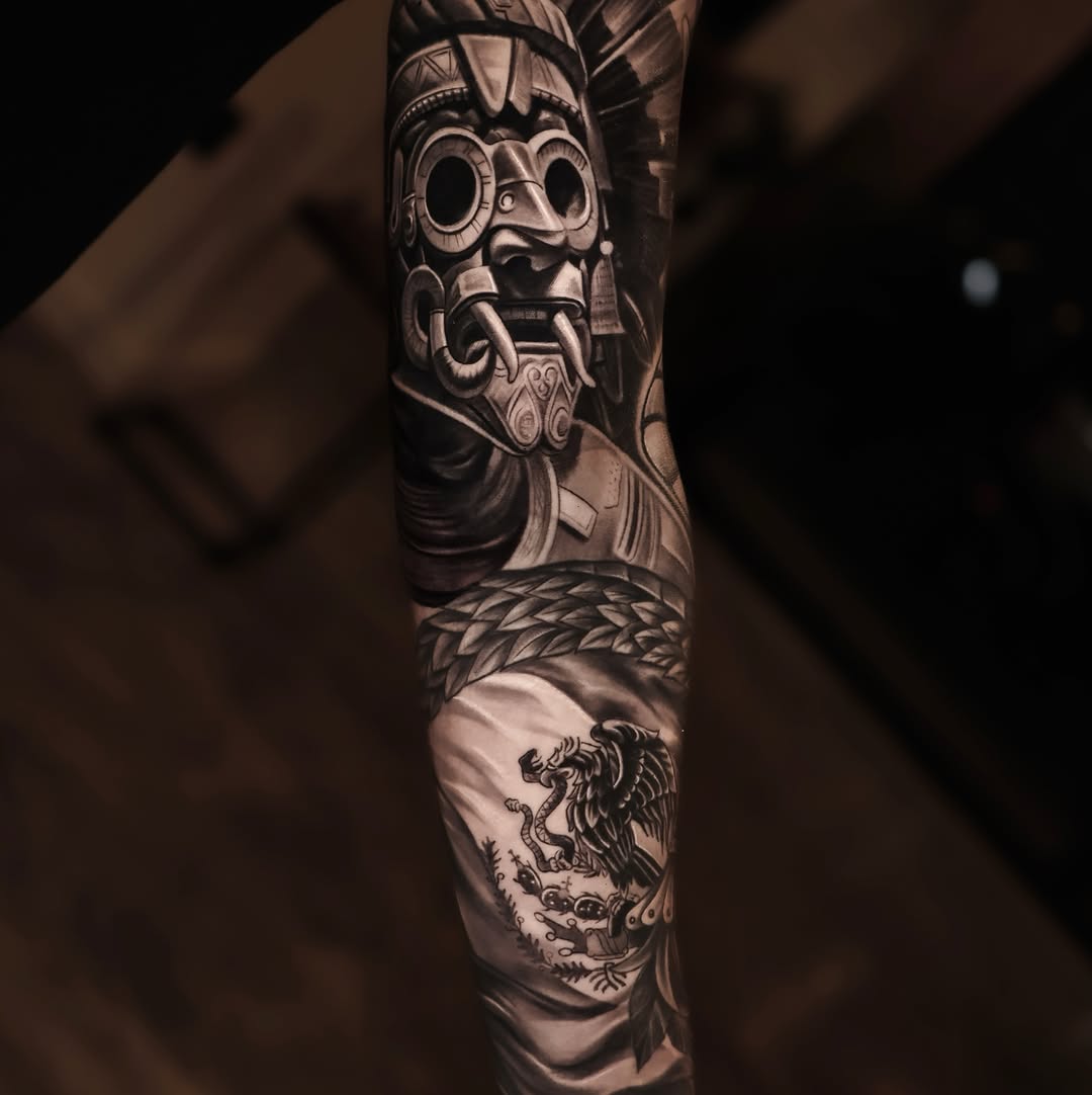 Aztec mask and Mexican flag realism tattoo on the forearm by Steven Villegas�