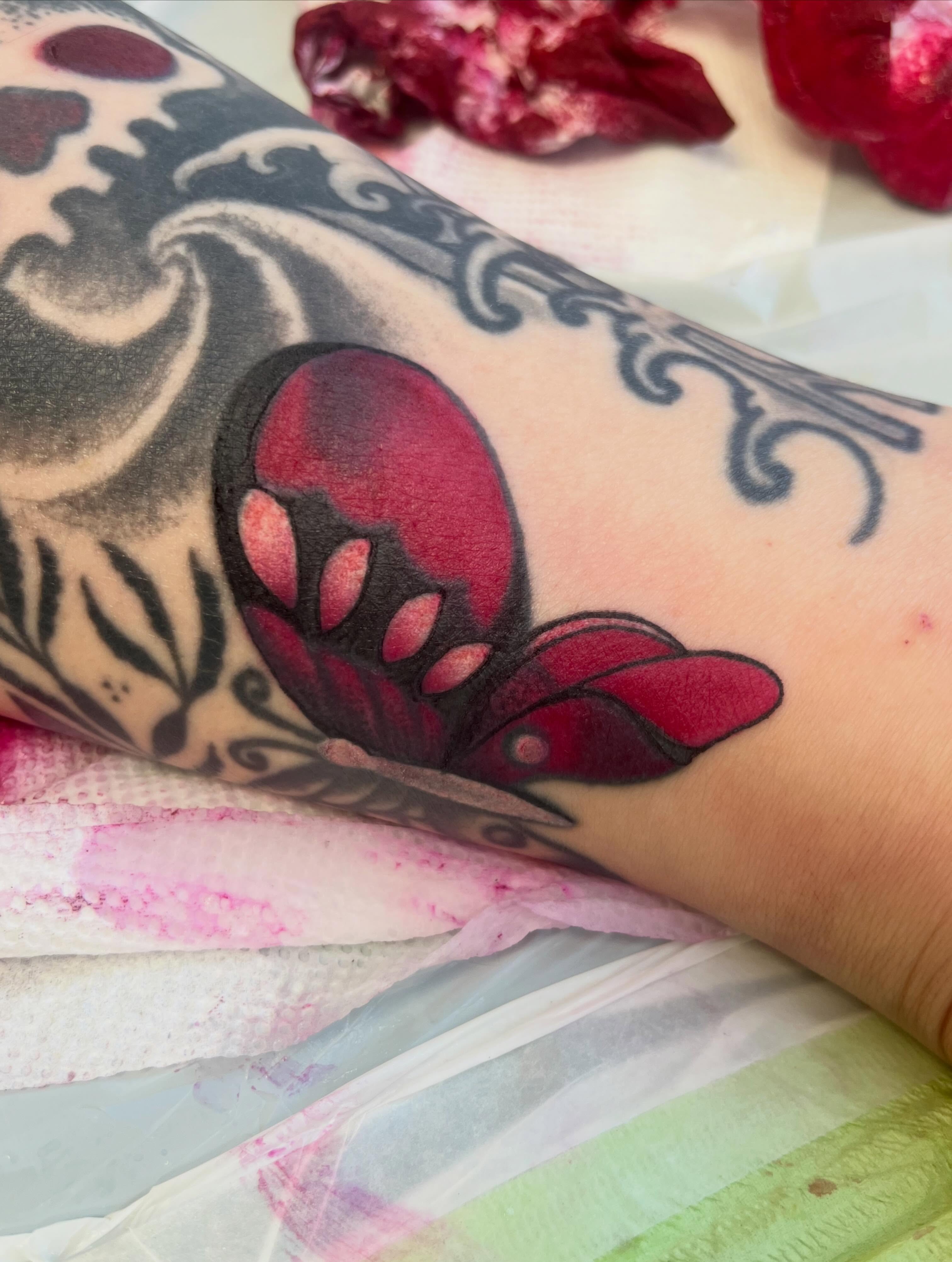 Butterfly American traditional tattoo on the forearm by Garden Glow Tattoo