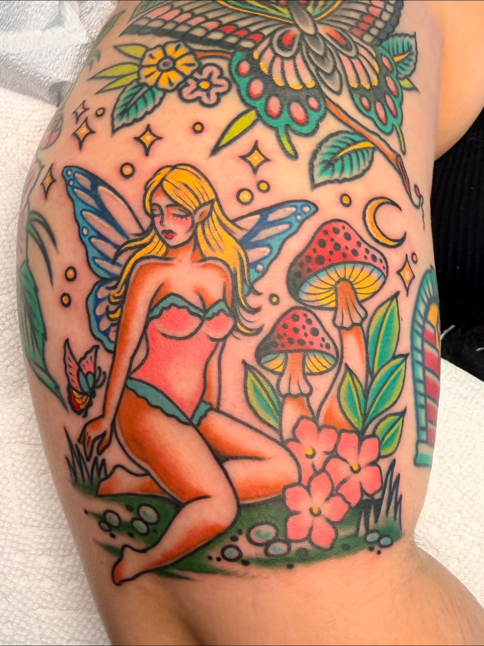 Fairy and mushrooms American traditional tattoo on the thigh by Macy Bird
