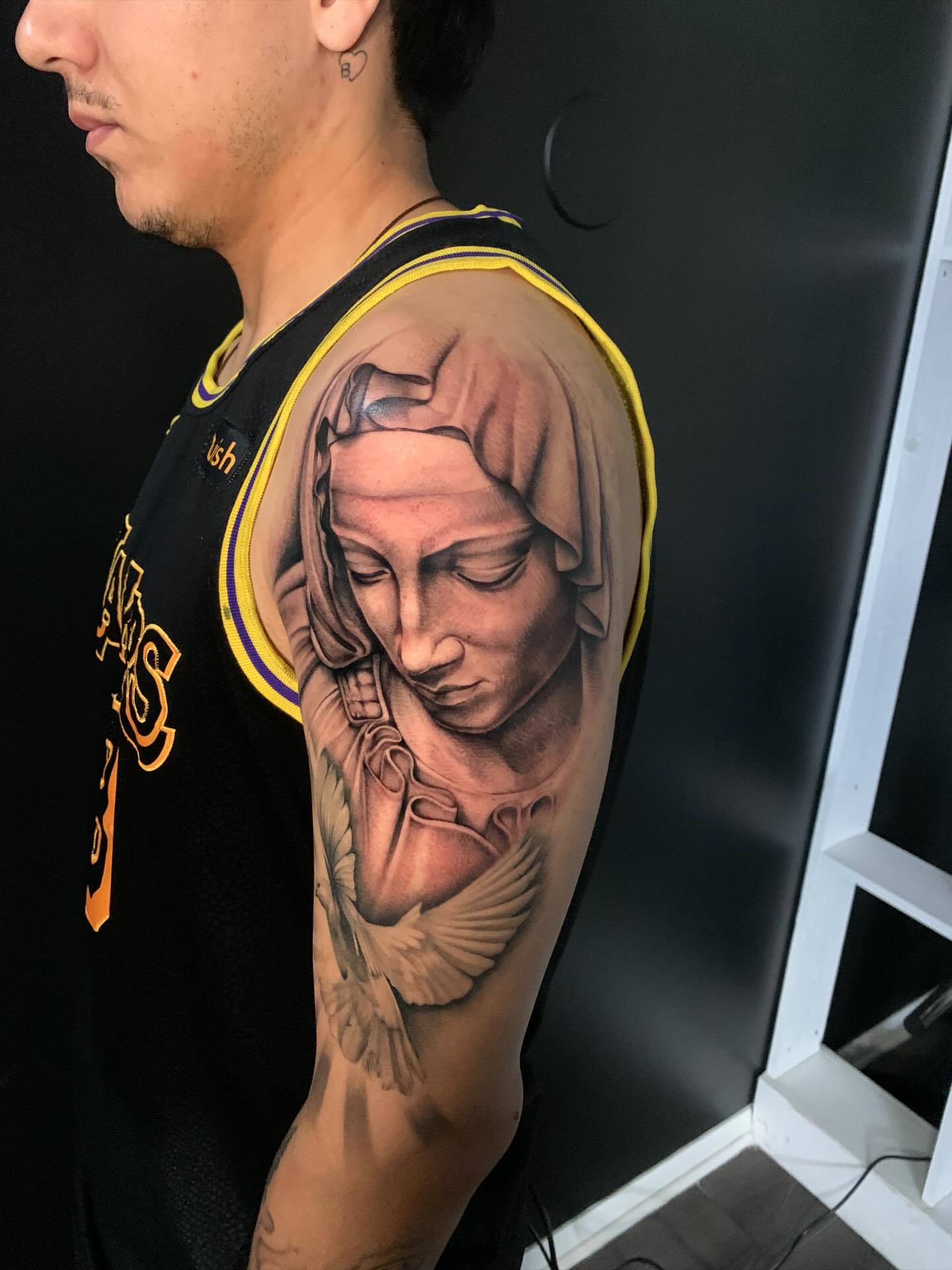 Statue realism tattoo on the upper arm by HAiZiE
