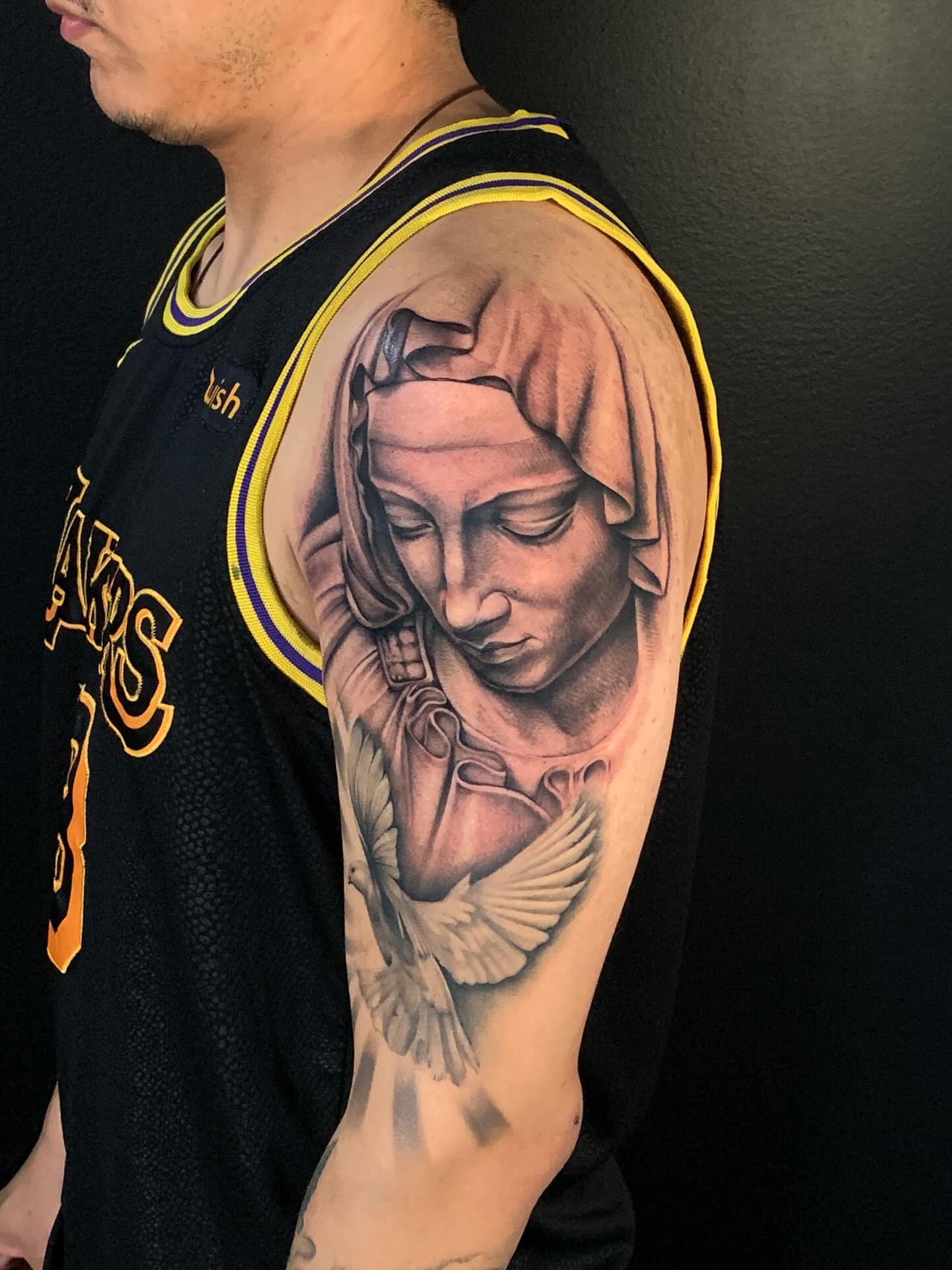 Statue of woman with dove realism tattoo on the shoulder by HAiZiE