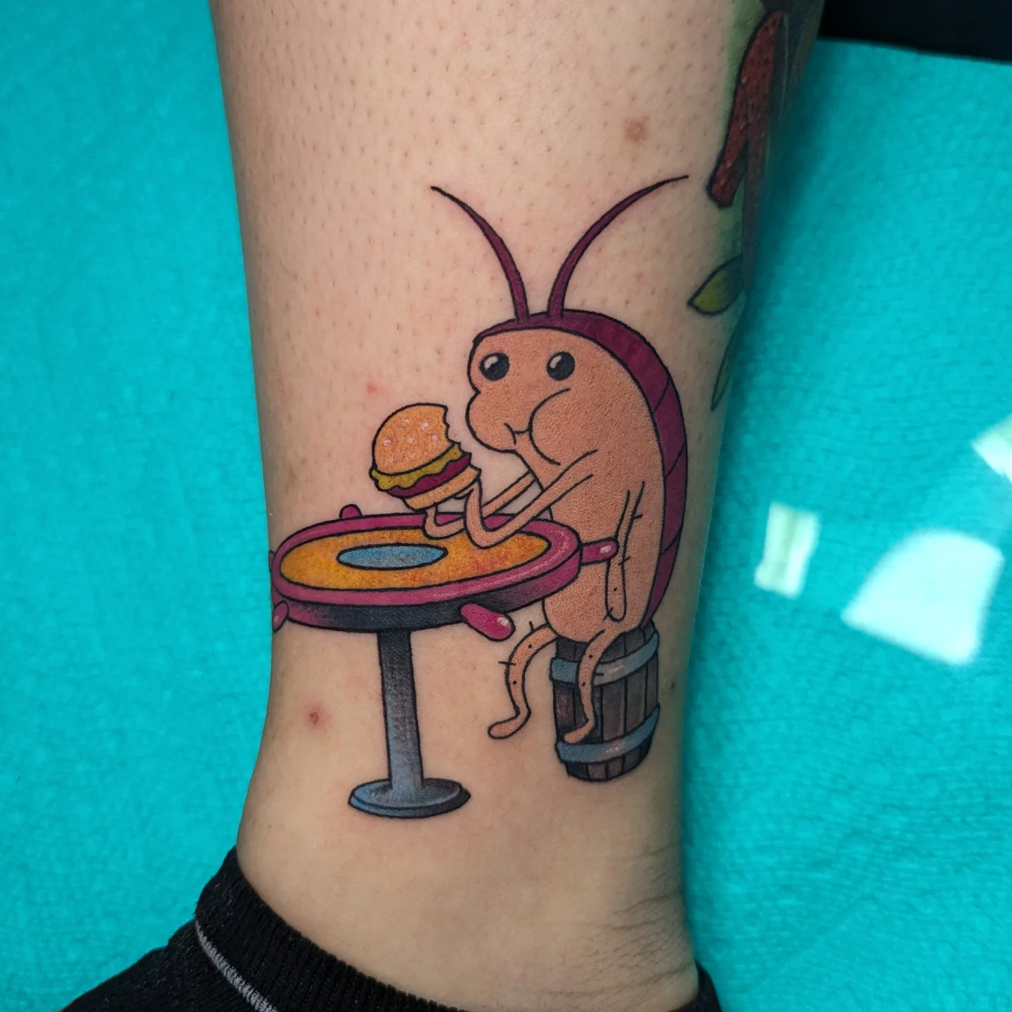 Insect eating burger illustrative tattoo on the forearm by 𝐈𝐚𝐧 𝐒𝐞𝐭𝐡 🕷️ Austin