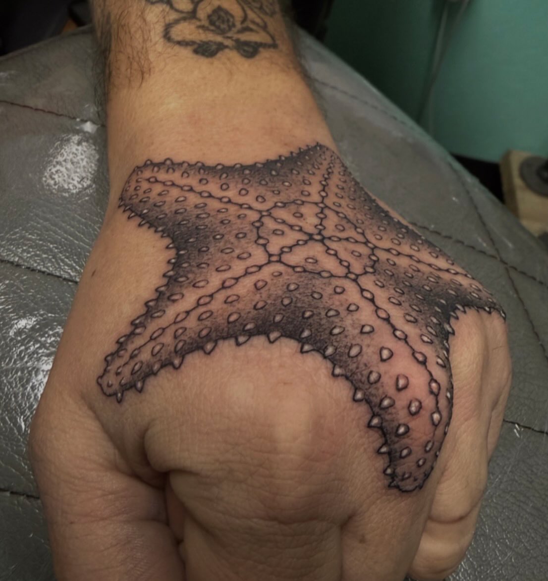 Starfish dotwork tattoo on the hand by Austin Tattoo Artist