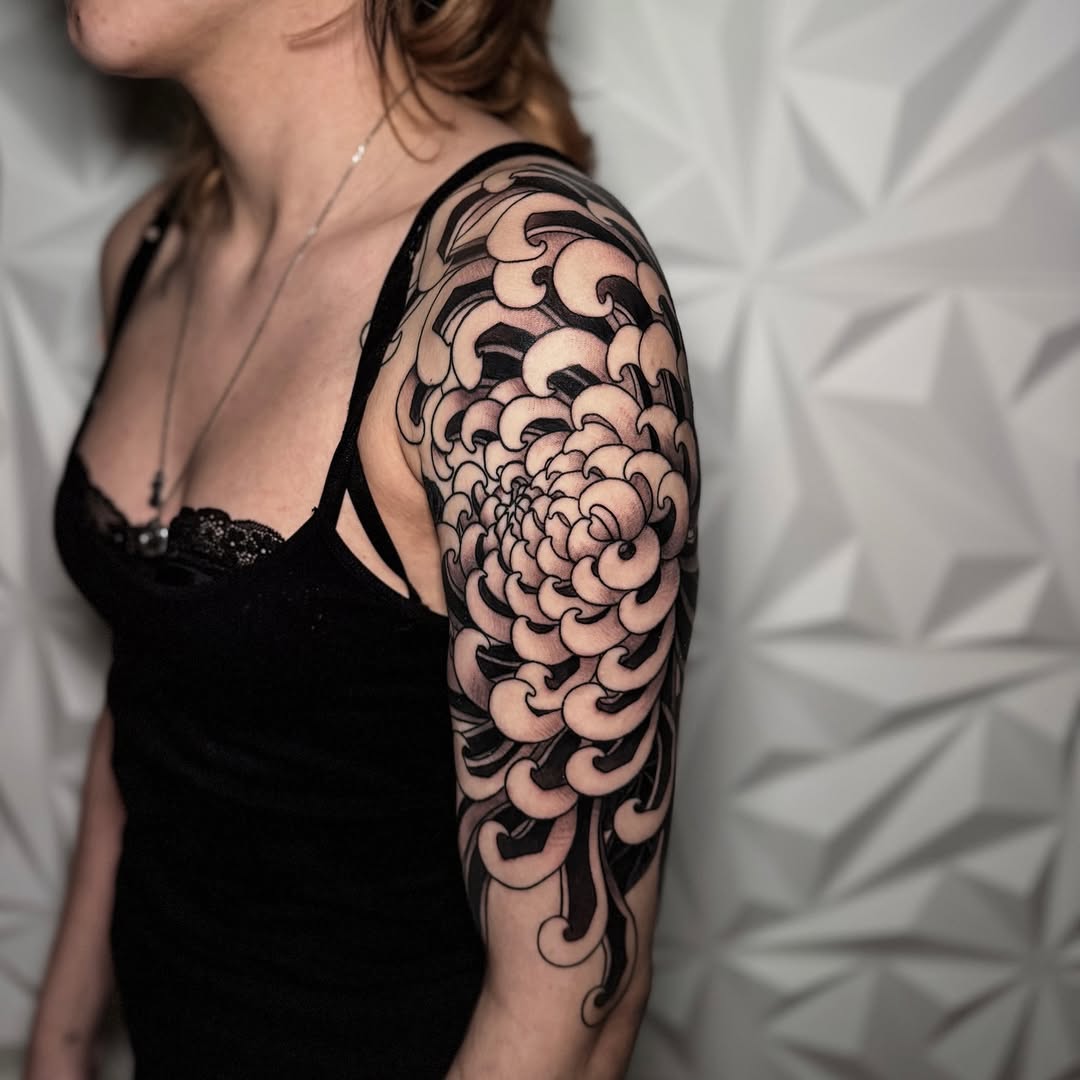 Chrysanthemum flower Japanese tattoo on the upper arm by Matt Trimble, Charlotte, North Carolina