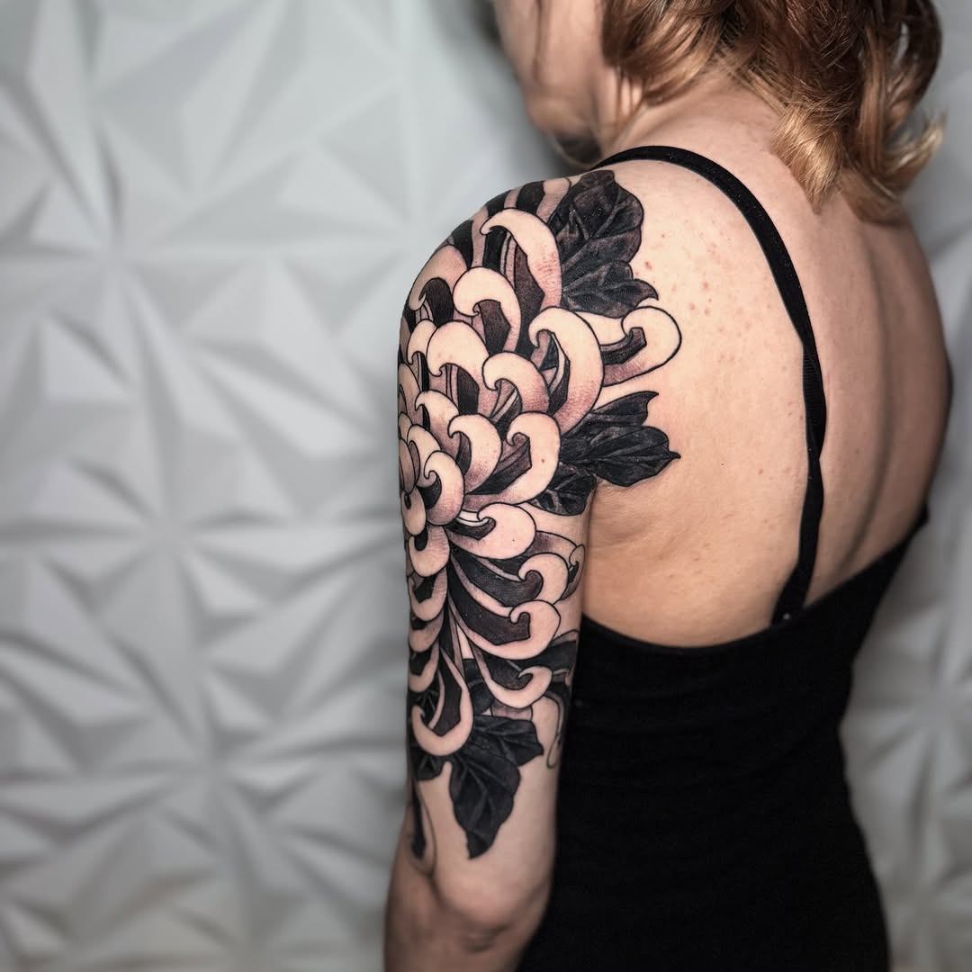 Chrysanthemum flower Japanese tattoo on the upper arm by Matt Trimble, Charlotte, North Carolina