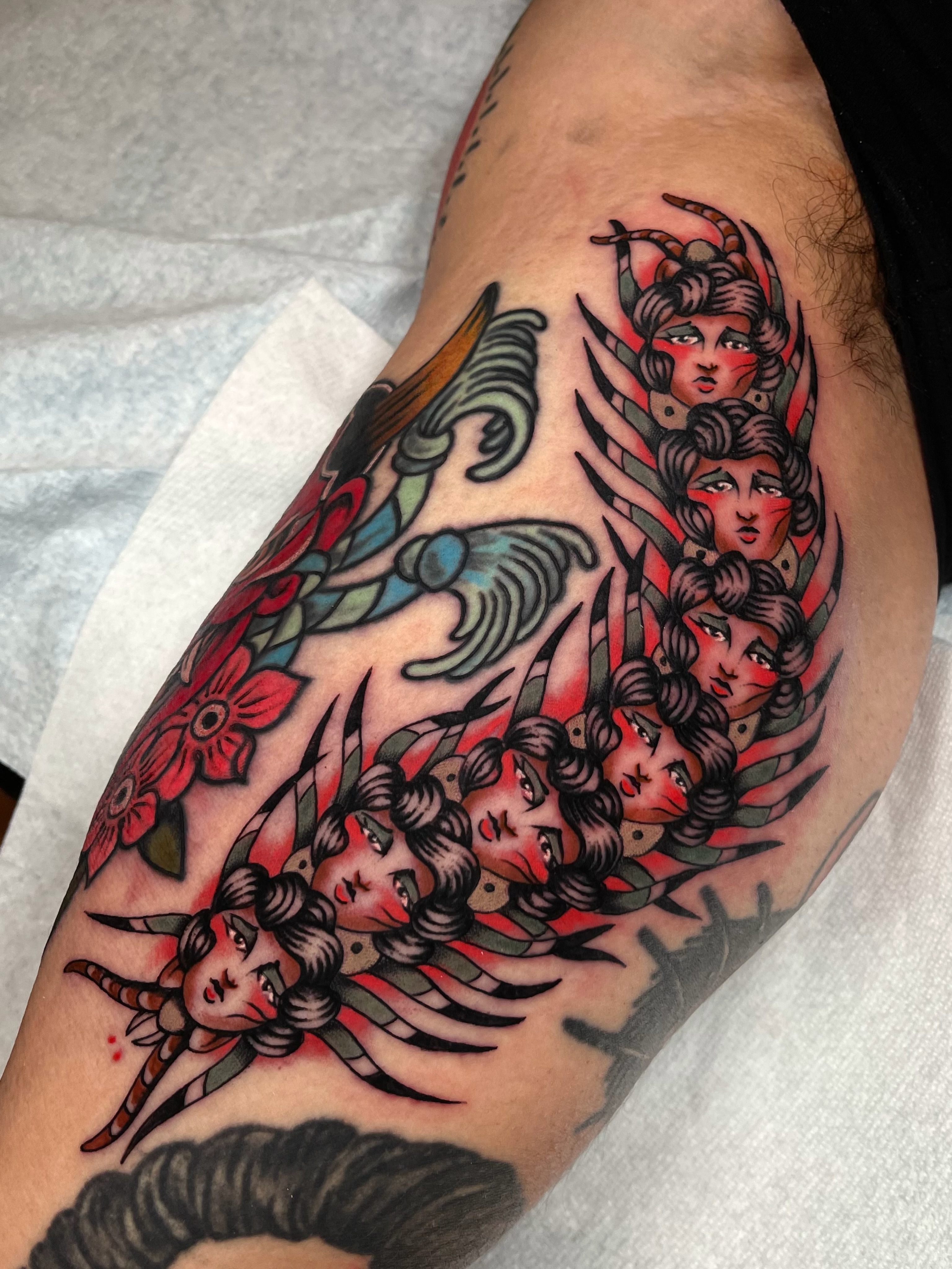 Female faces American traditional tattoo on the forearm by Casey Sullivan, San Diego, California