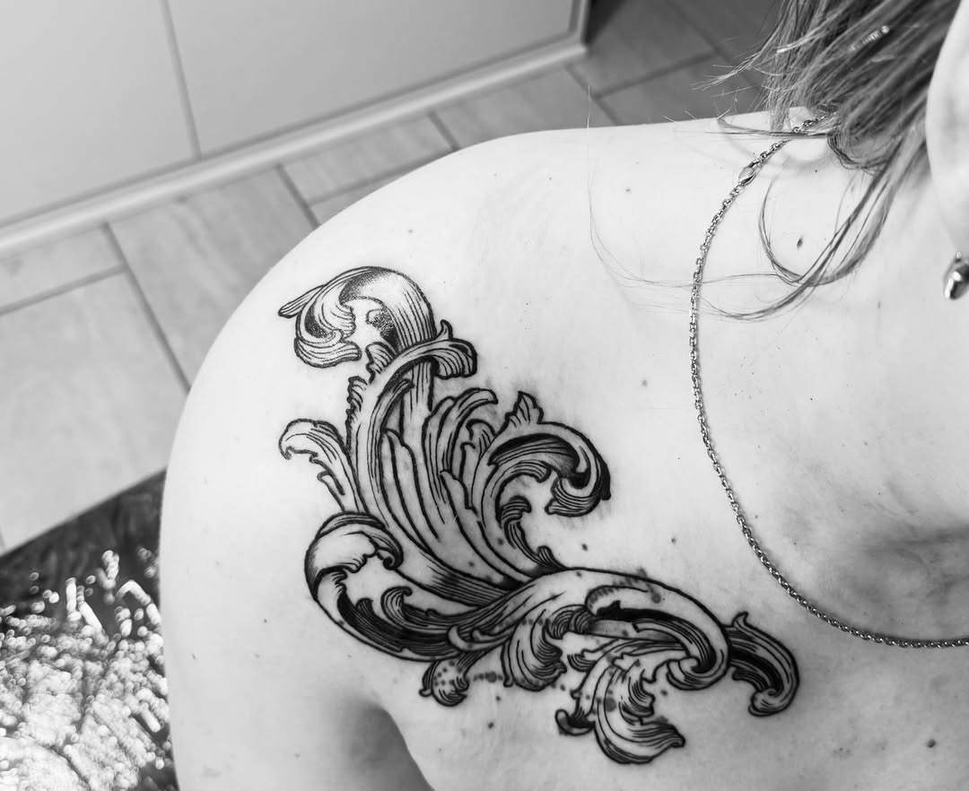 Scrollwork ornamental tattoo on the shoulder by Noir