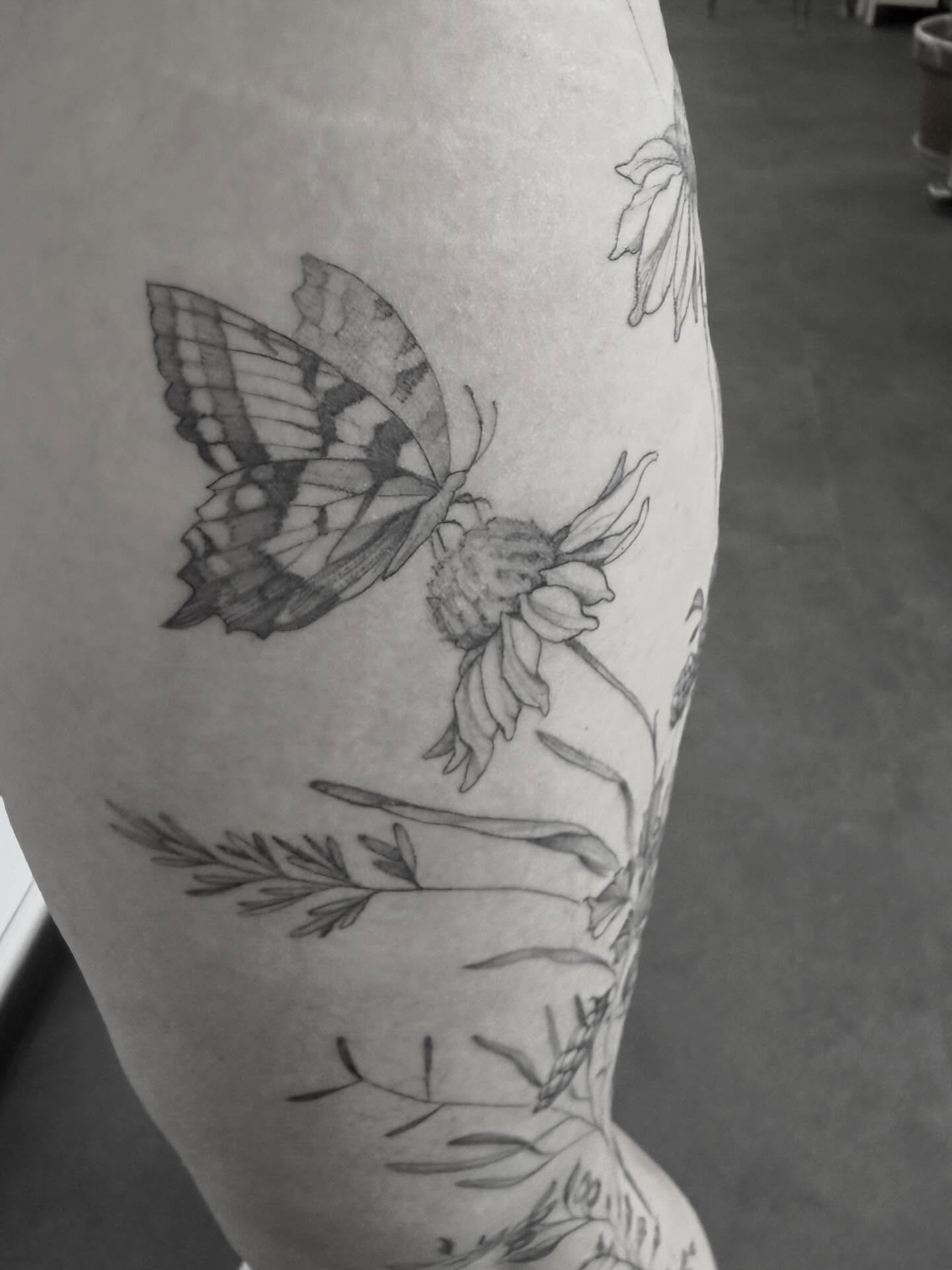Butterfly and flowers realism tattoo on the forearm by Peter Harren