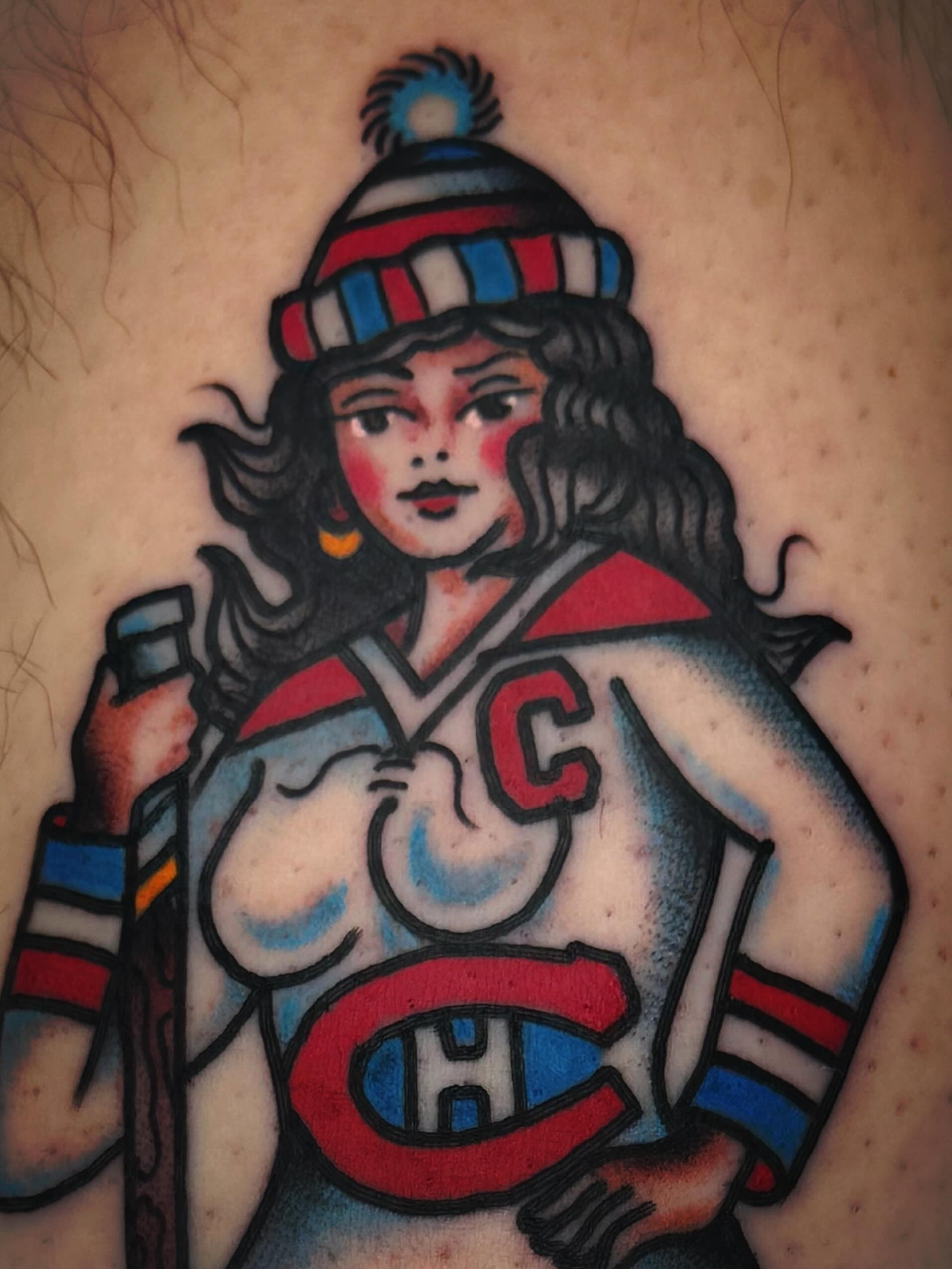 Hockey girl American traditional tattoo on the thigh by Mikey Sarratt