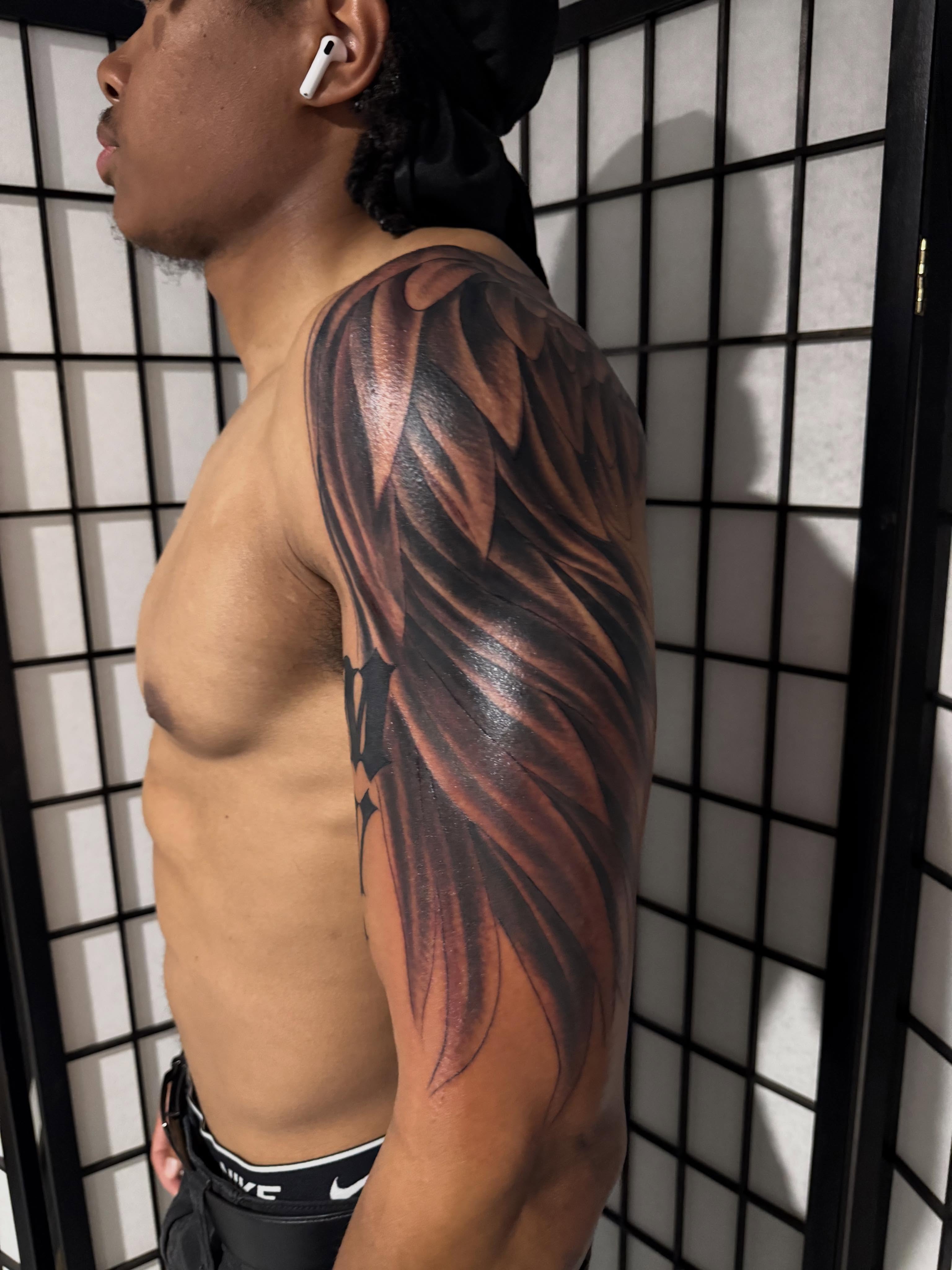 Wing realism tattoo on the upper arm by Randall Croley El