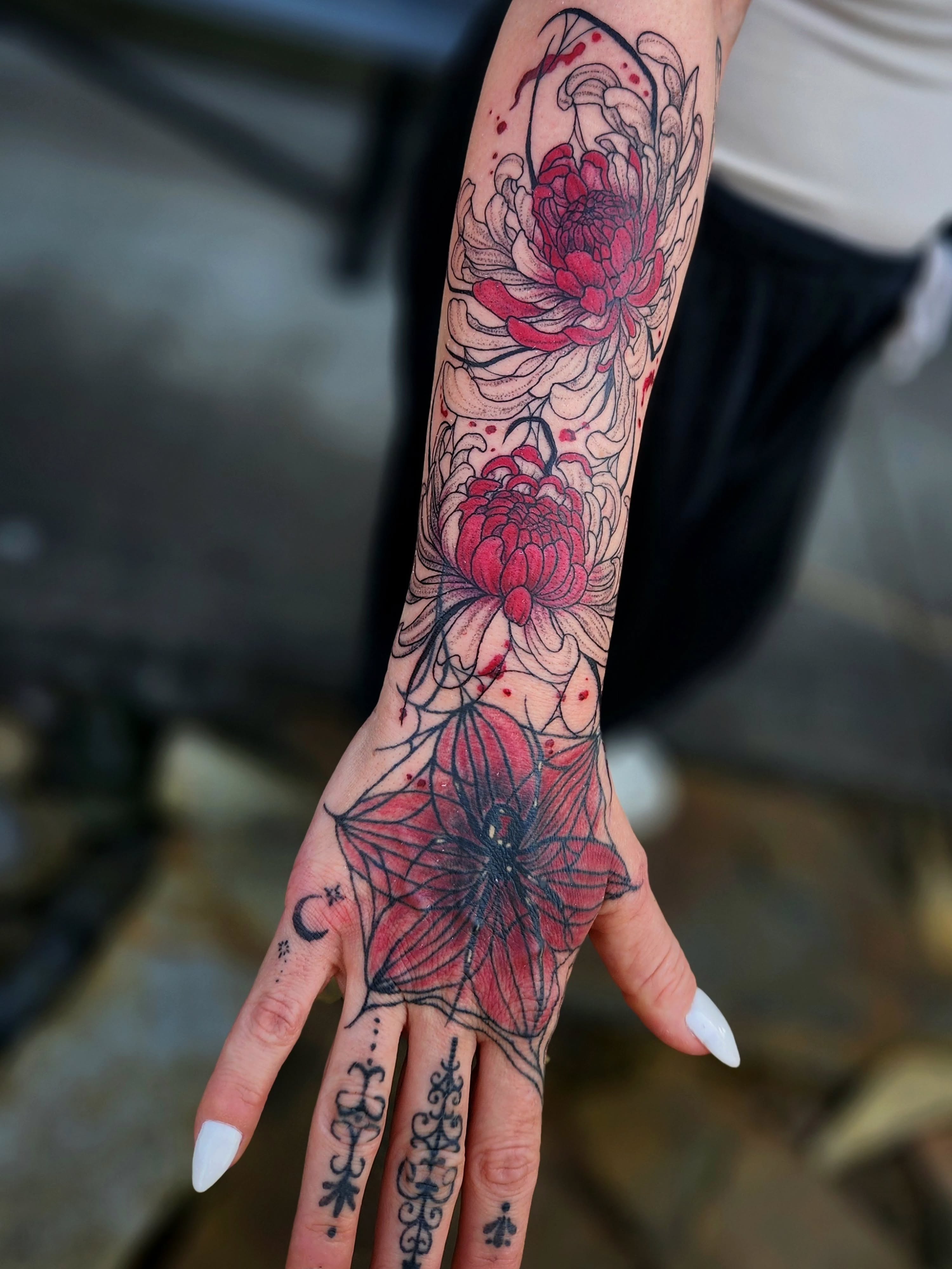 Chrysanthemums dotwork tattoo on the forearm by Ashly Renee