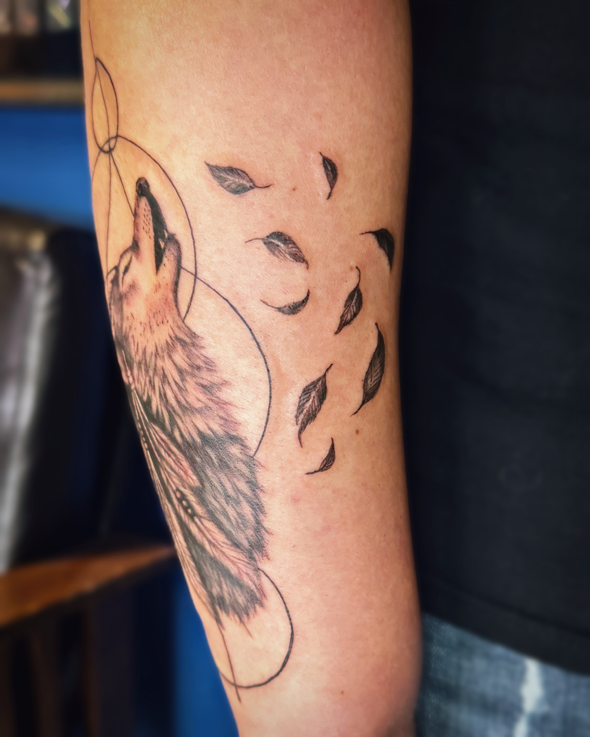 Wolf howling at moon realism tattoo on the forearm by Kate