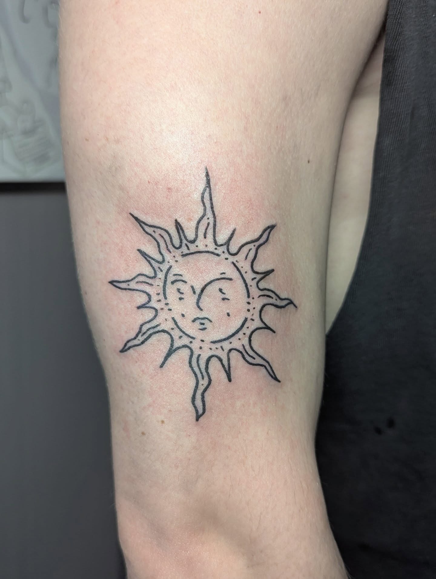 Sun black and grey tattoo on the forearm by Patricio