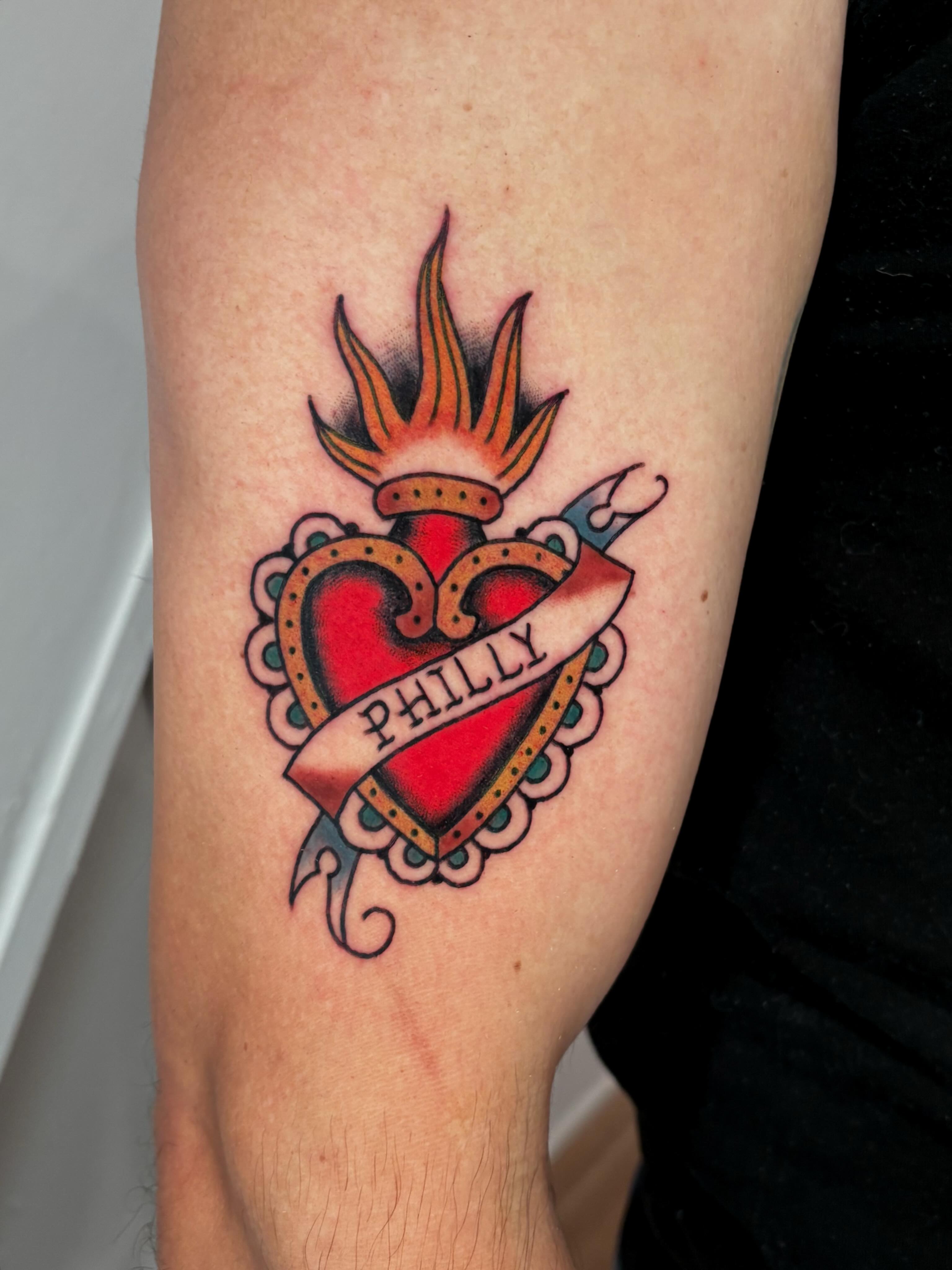 Heart with flame American traditional tattoo on the forearm by Evan Bisso, Philadelphia, Pennsylvania