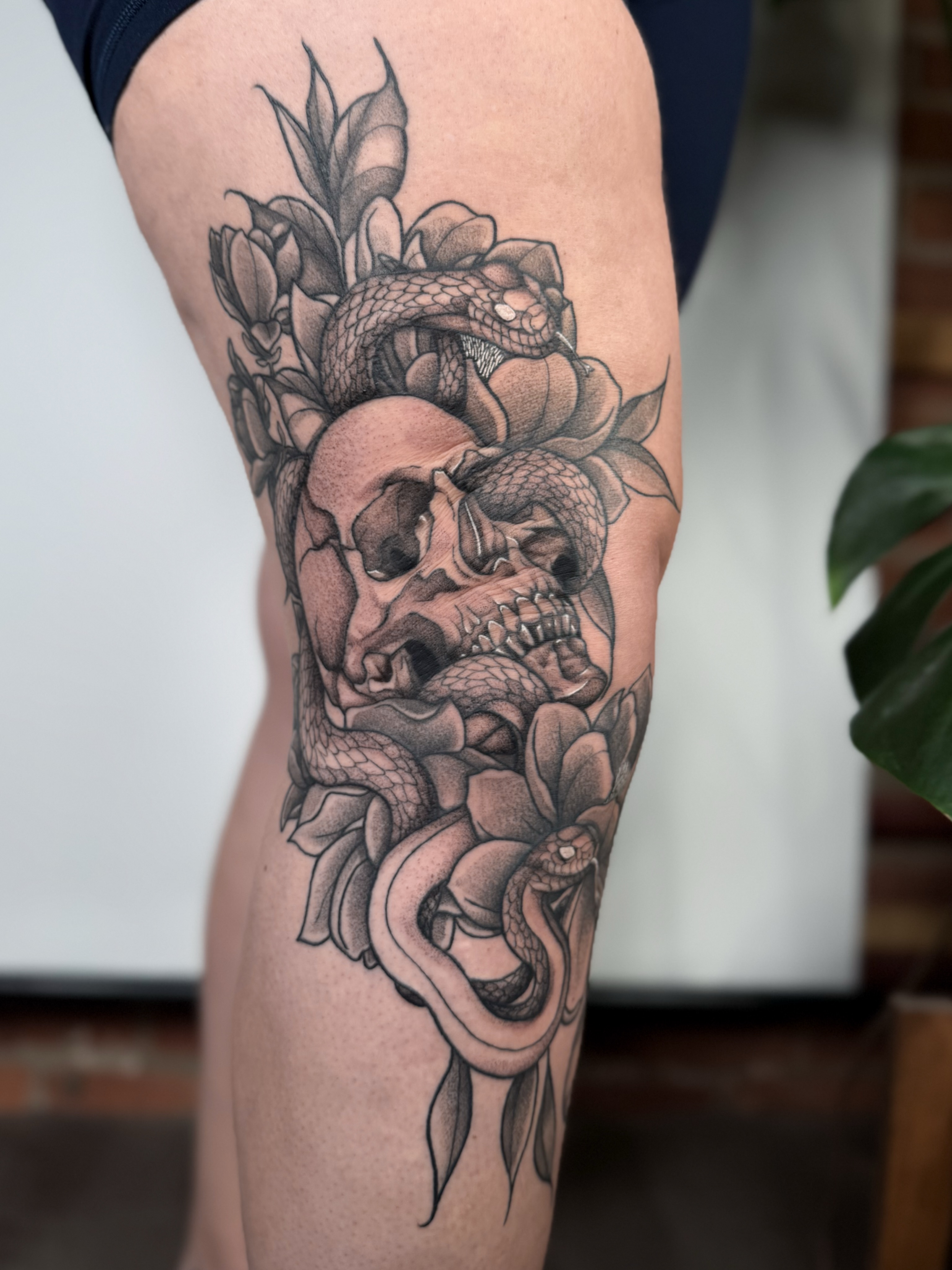 Snake and skull realism tattoo on the thigh by Jessica Bloom