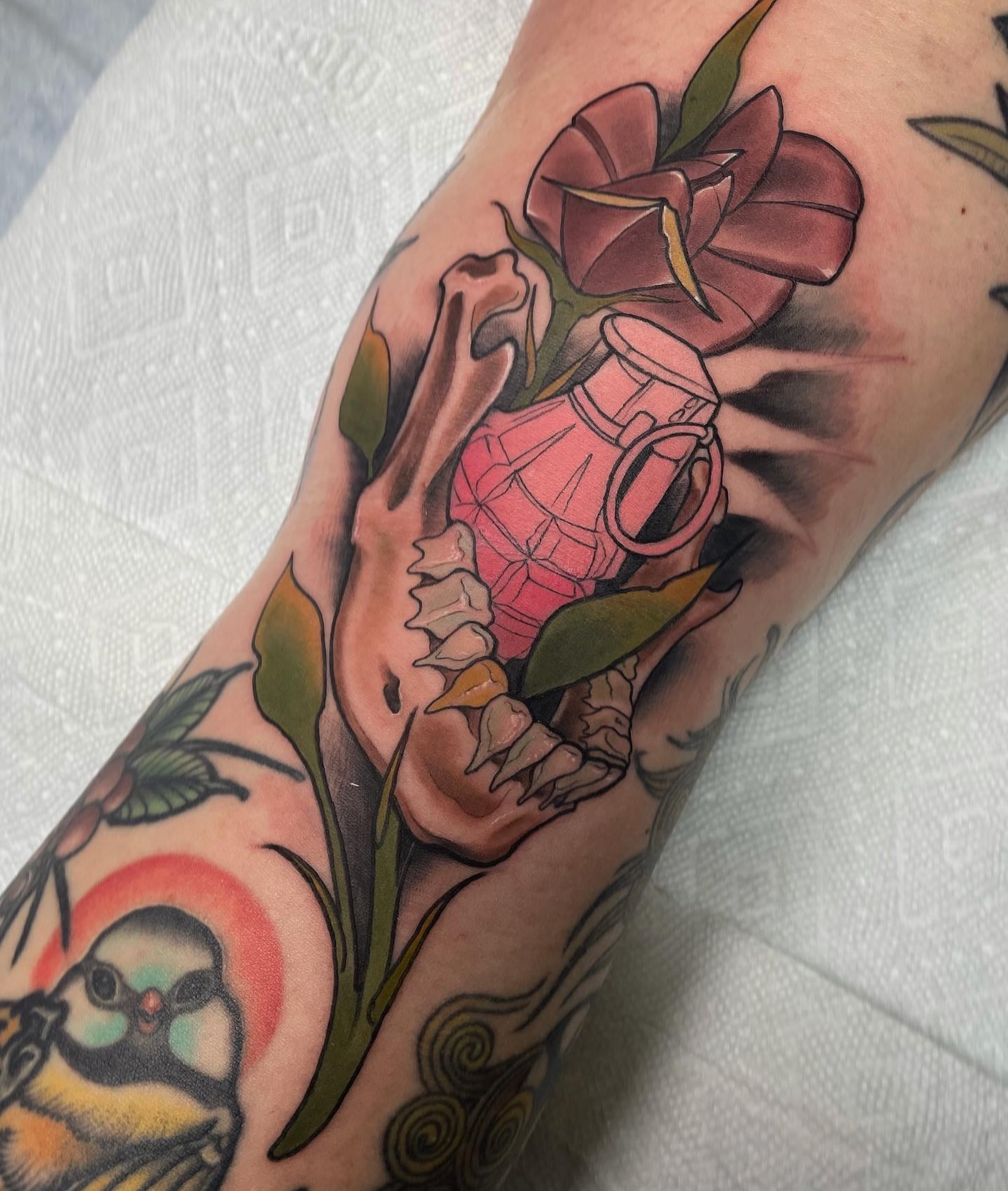 Flower and grenade American traditional tattoo on the forearm by Jenn Golgan
