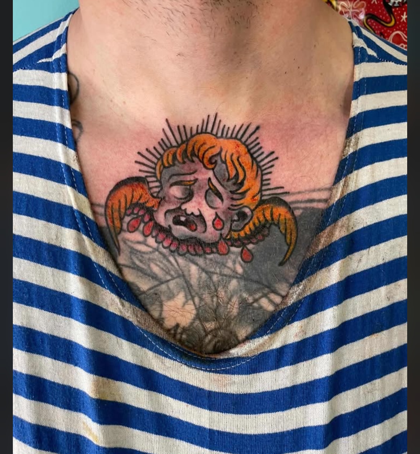 Joker skull American traditional tattoo on the chest by Cody Wallenius, Merrillville, Indiana