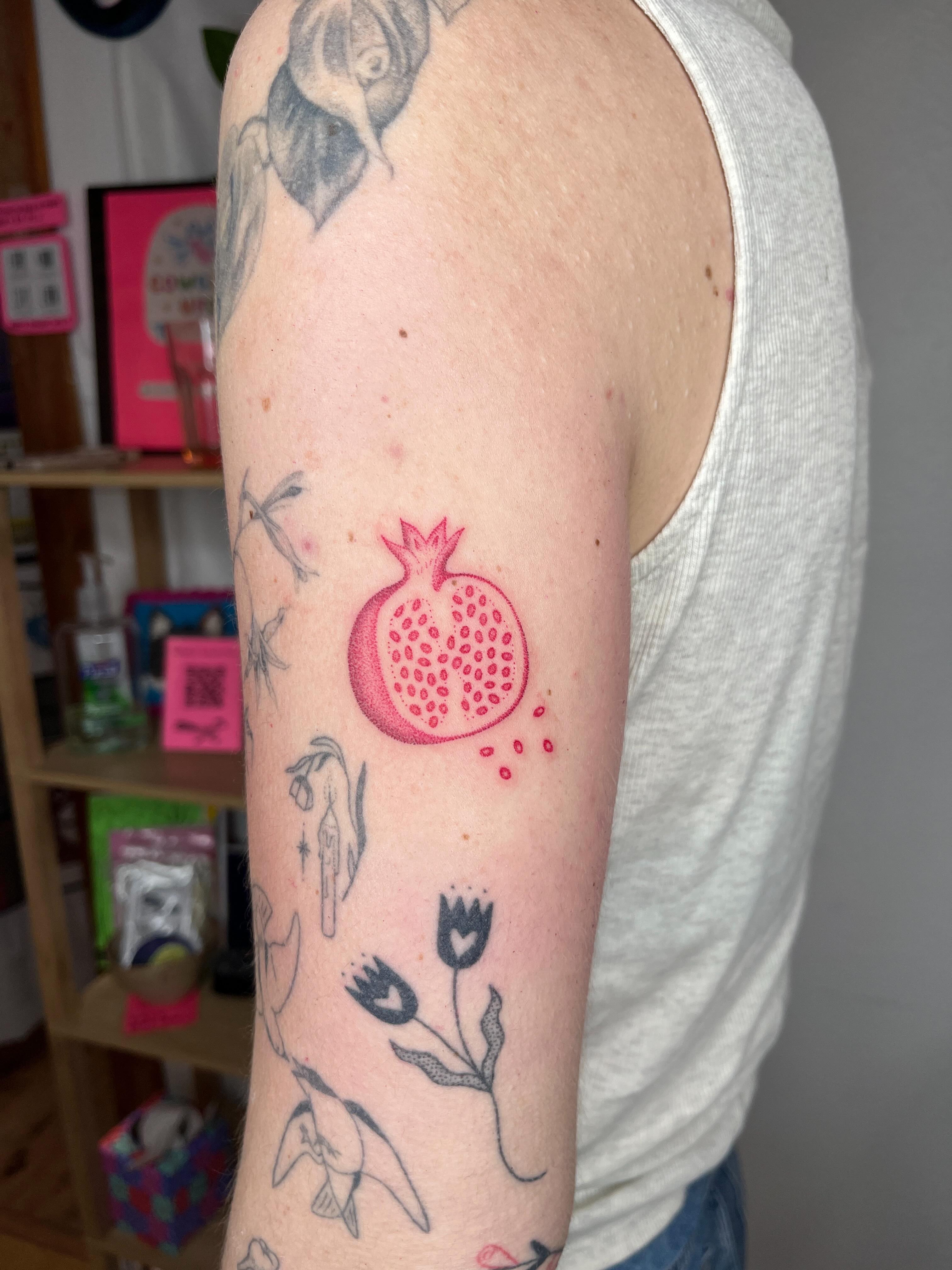 Pomegranate dotwork tattoo on the forearm by natalie