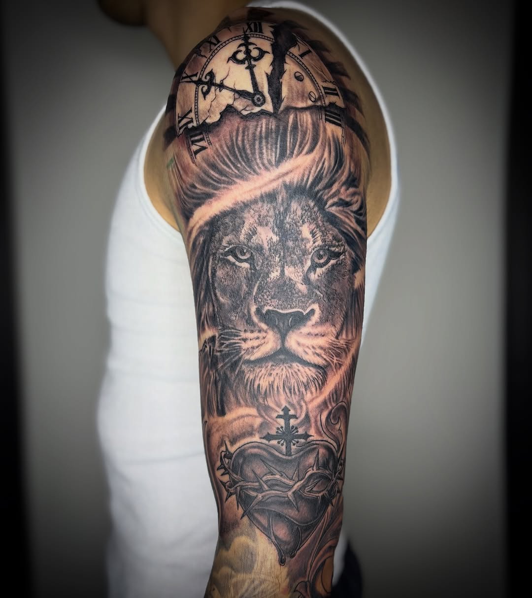 Lion, clock, and sacred heart realism tattoo on the forearm by Adrian Ram 🇬🇾🇵🇭