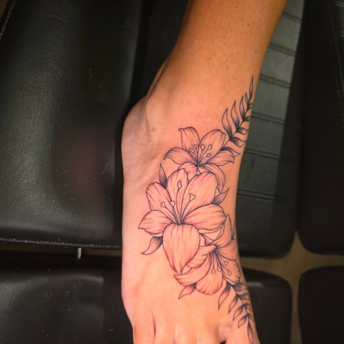Lilies realism tattoo on the hand by Maggie