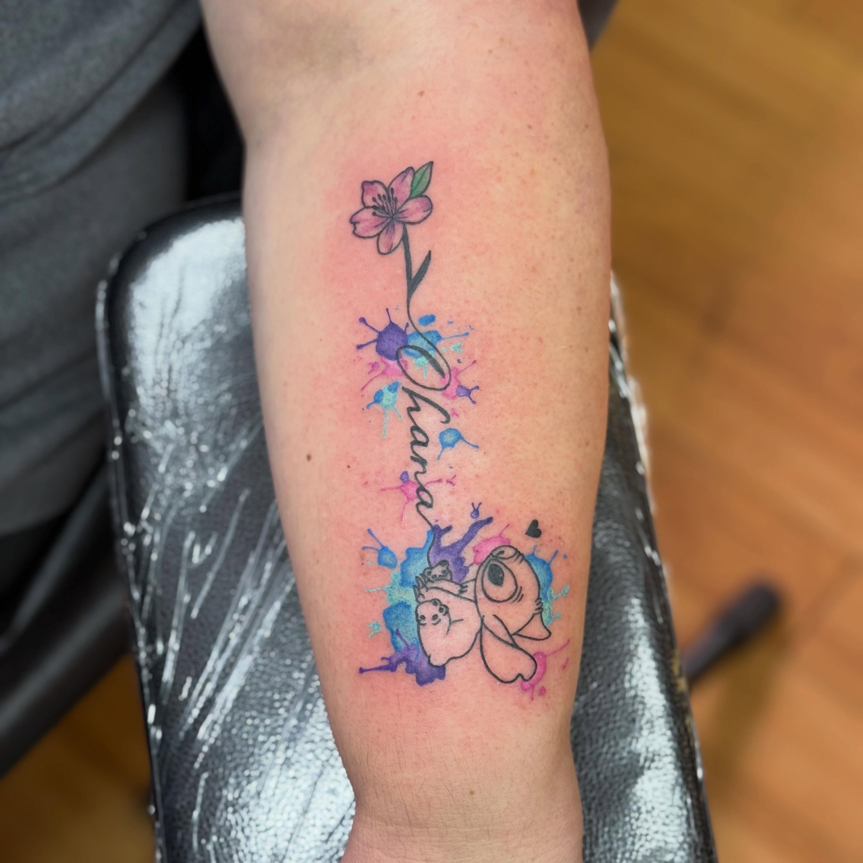 Ohana watercolor tattoo on the forearm by Nic