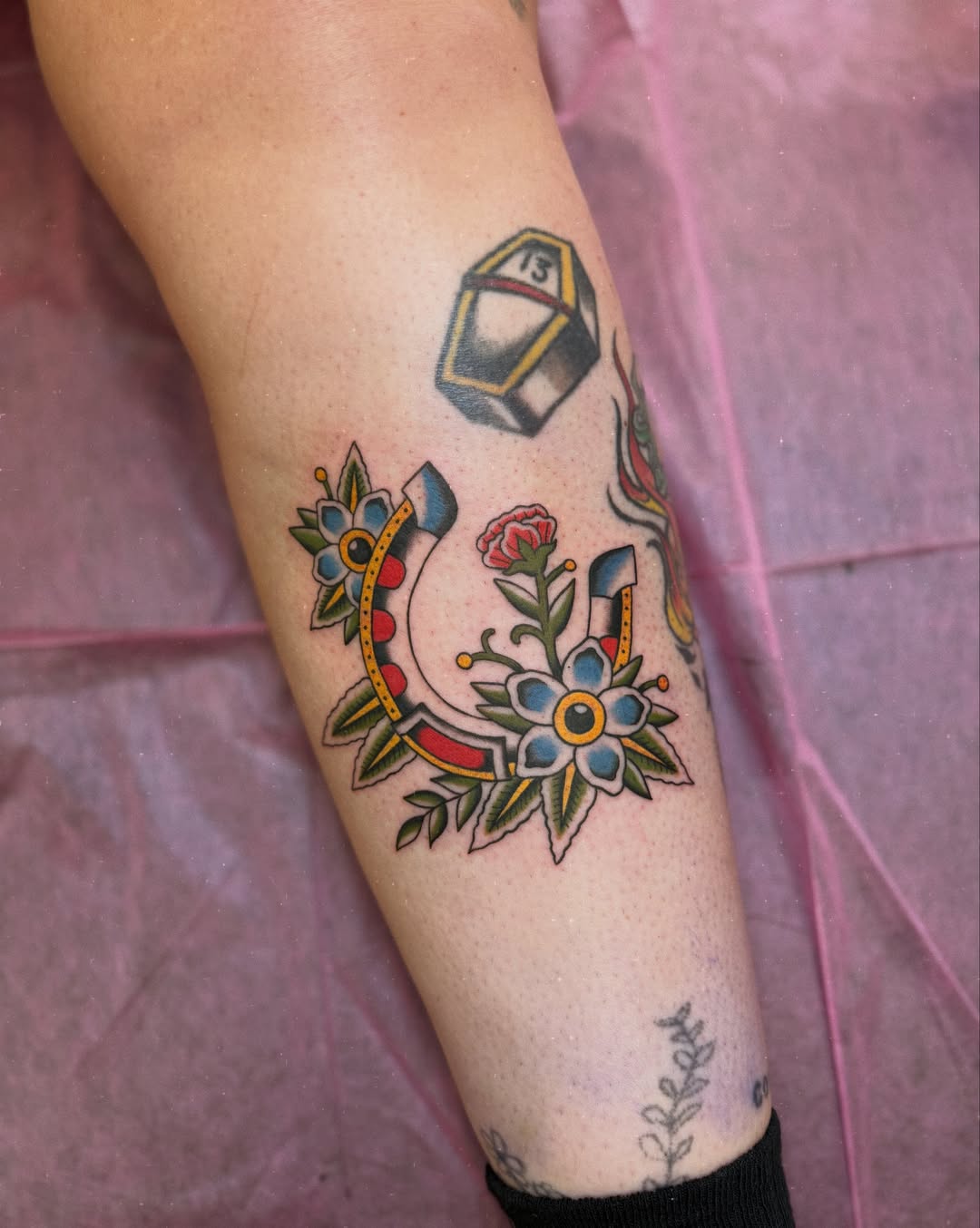 Anchor and floral American traditional tattoo on the forearm by charlie