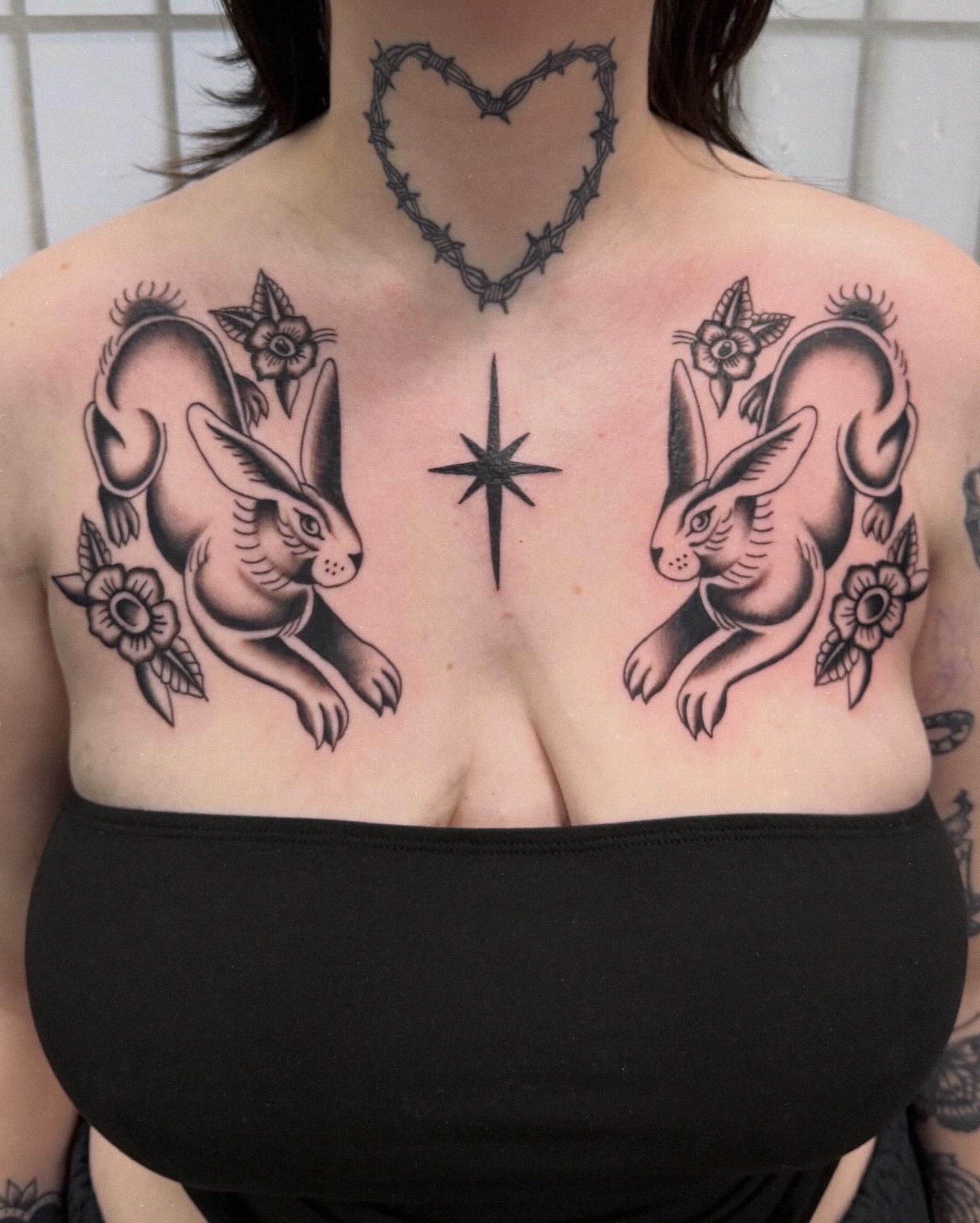 Rabbits and flowers black and grey tattoo on the chest by charlie