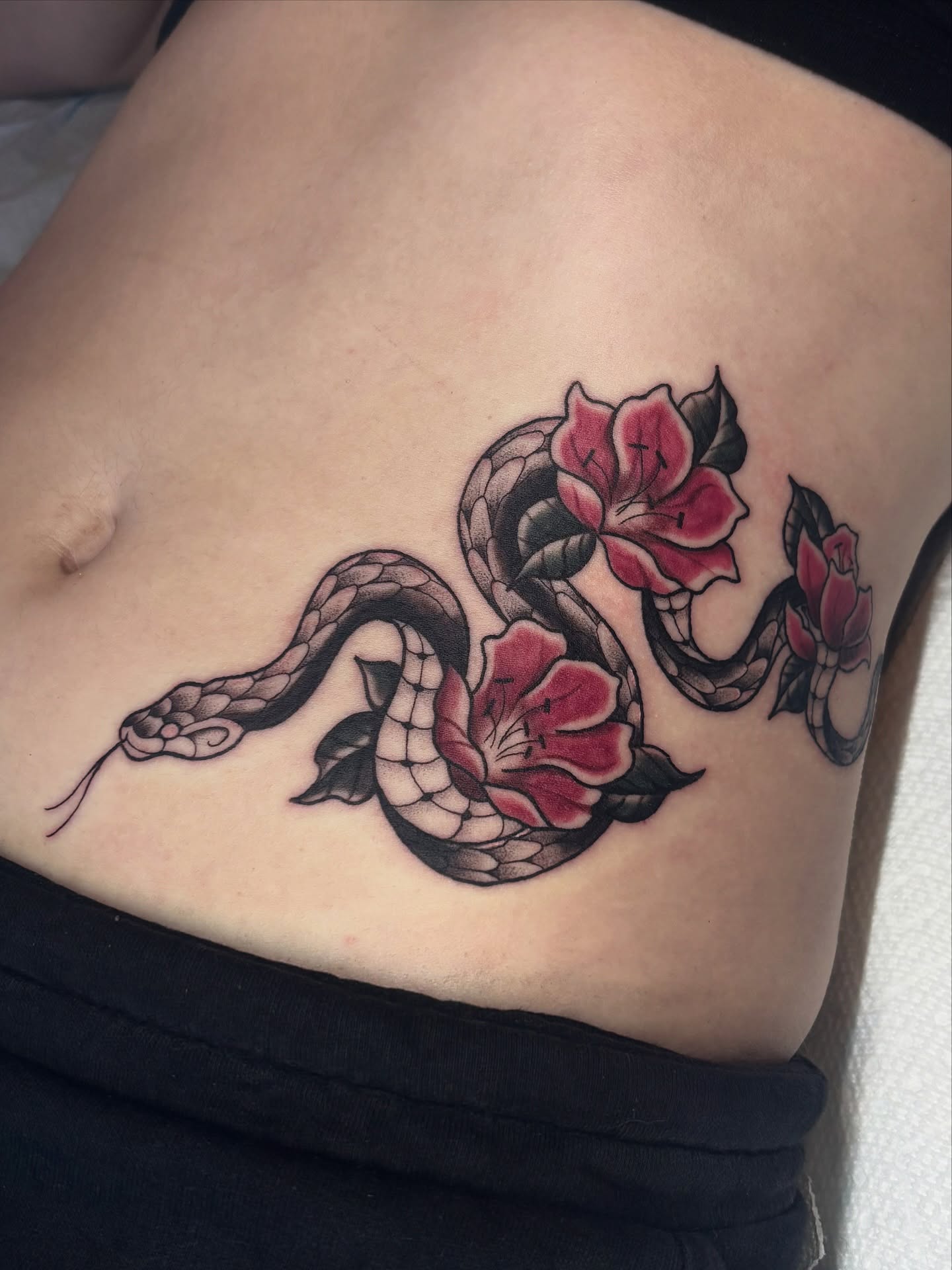 Snake and peony American traditional tattoo on the ribs by ๐ฅ Jas ๐ฅ