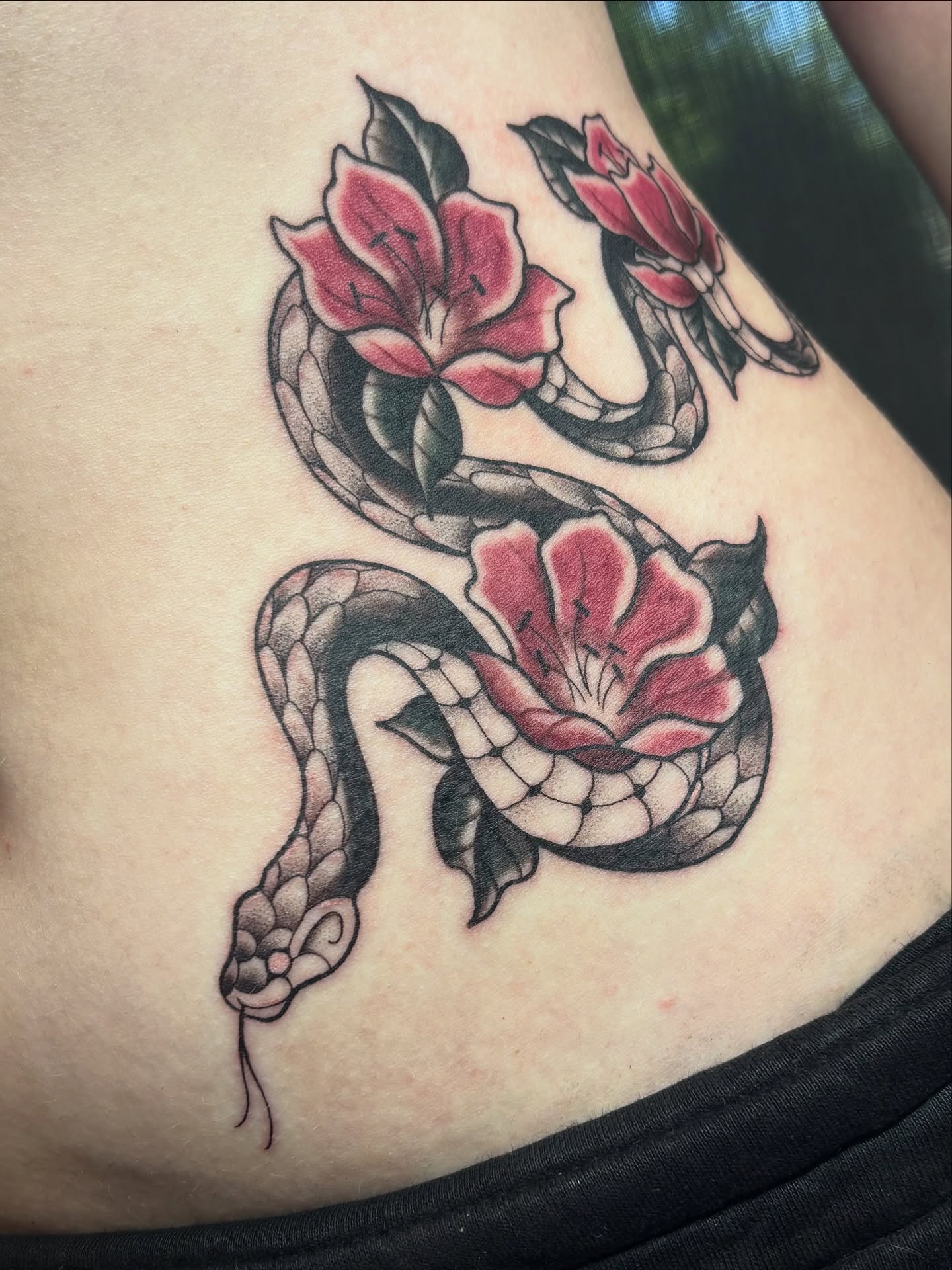 Snake and flowers American traditional tattoo on the ribs by ๐ฅ Jas ๐ฅ