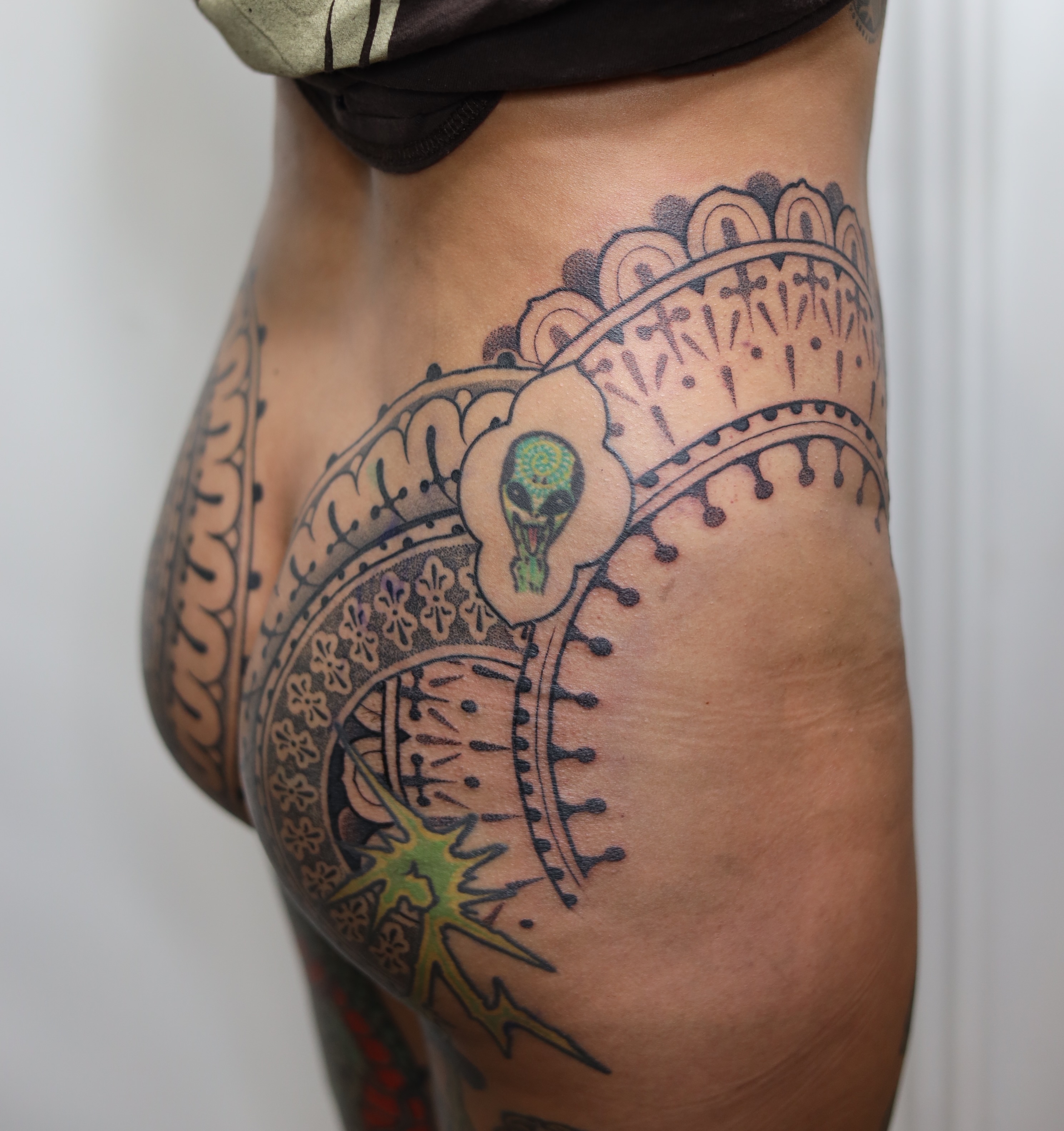 Alien flower dotwork tattoo on the thigh by Caleb Ortiz