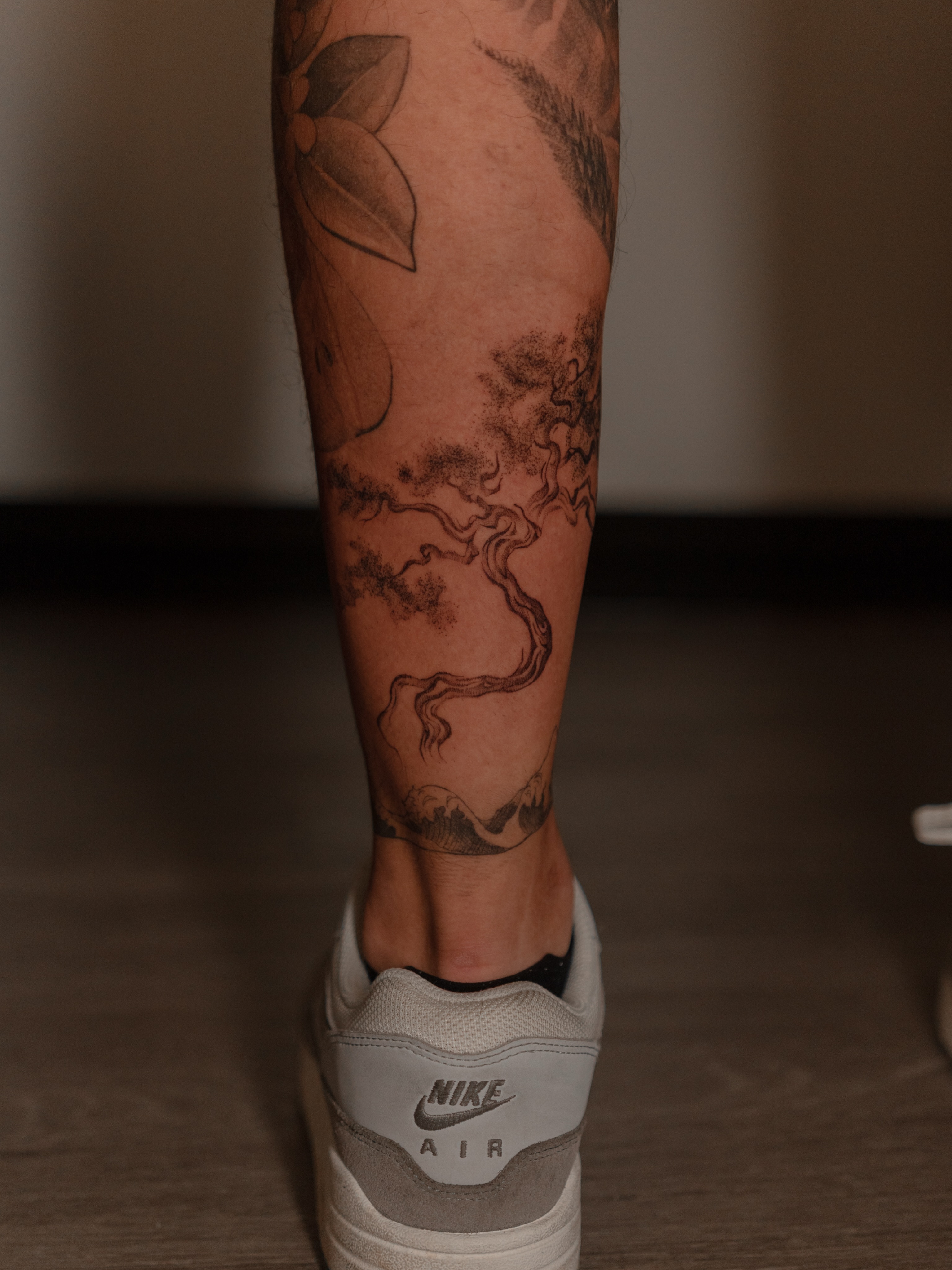 Tree and landscape black and grey tattoo on the calf by Jen- San Antonio tattoo artist