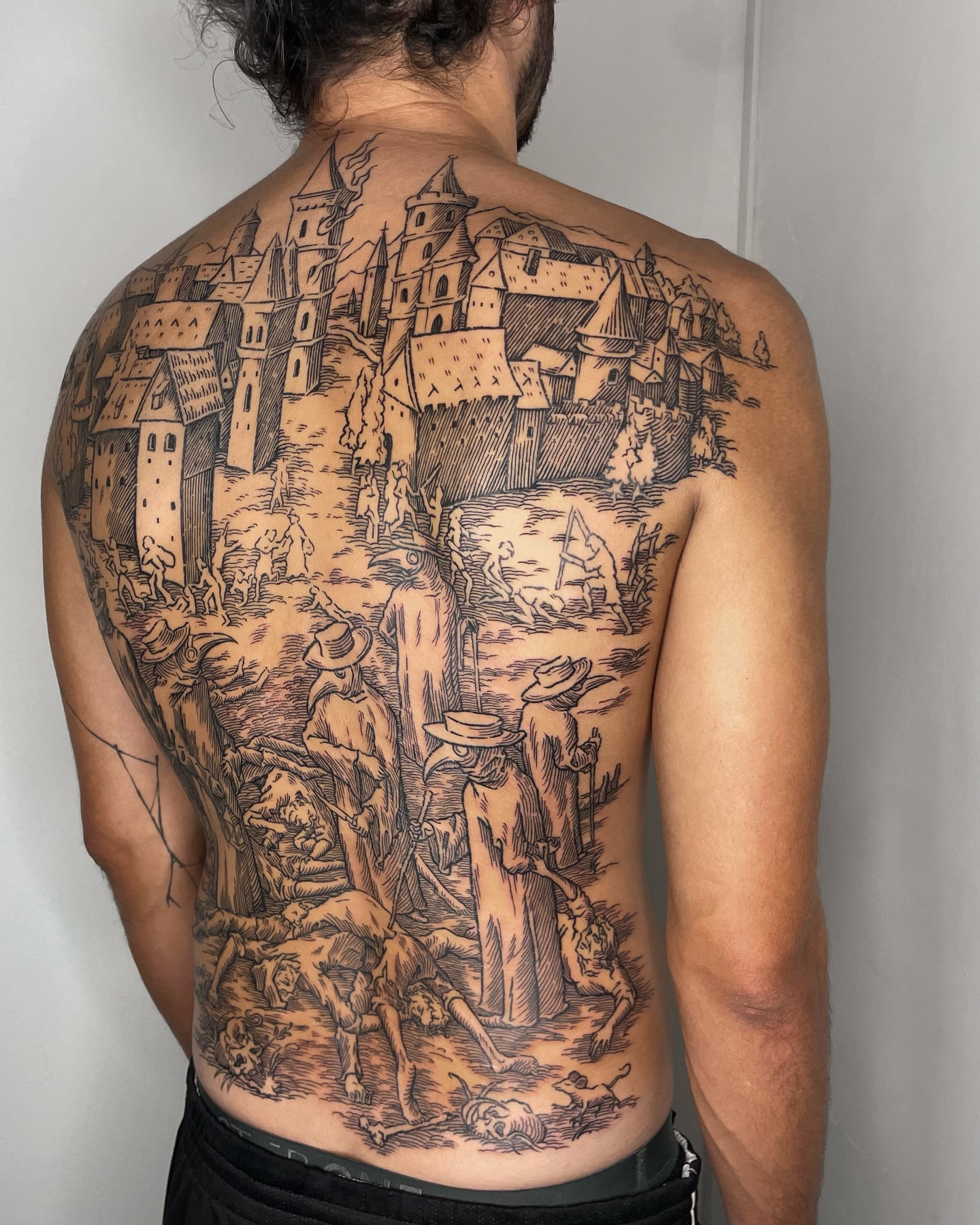 Medieval village scene realism tattoo on the back by Anh Đan