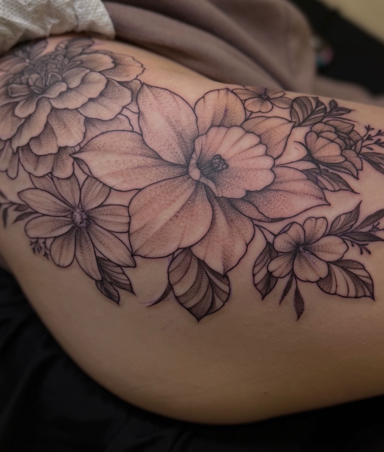 Floral arrangement dotwork tattoo on the thigh by Rikky Bobby, Mesa, Arizona