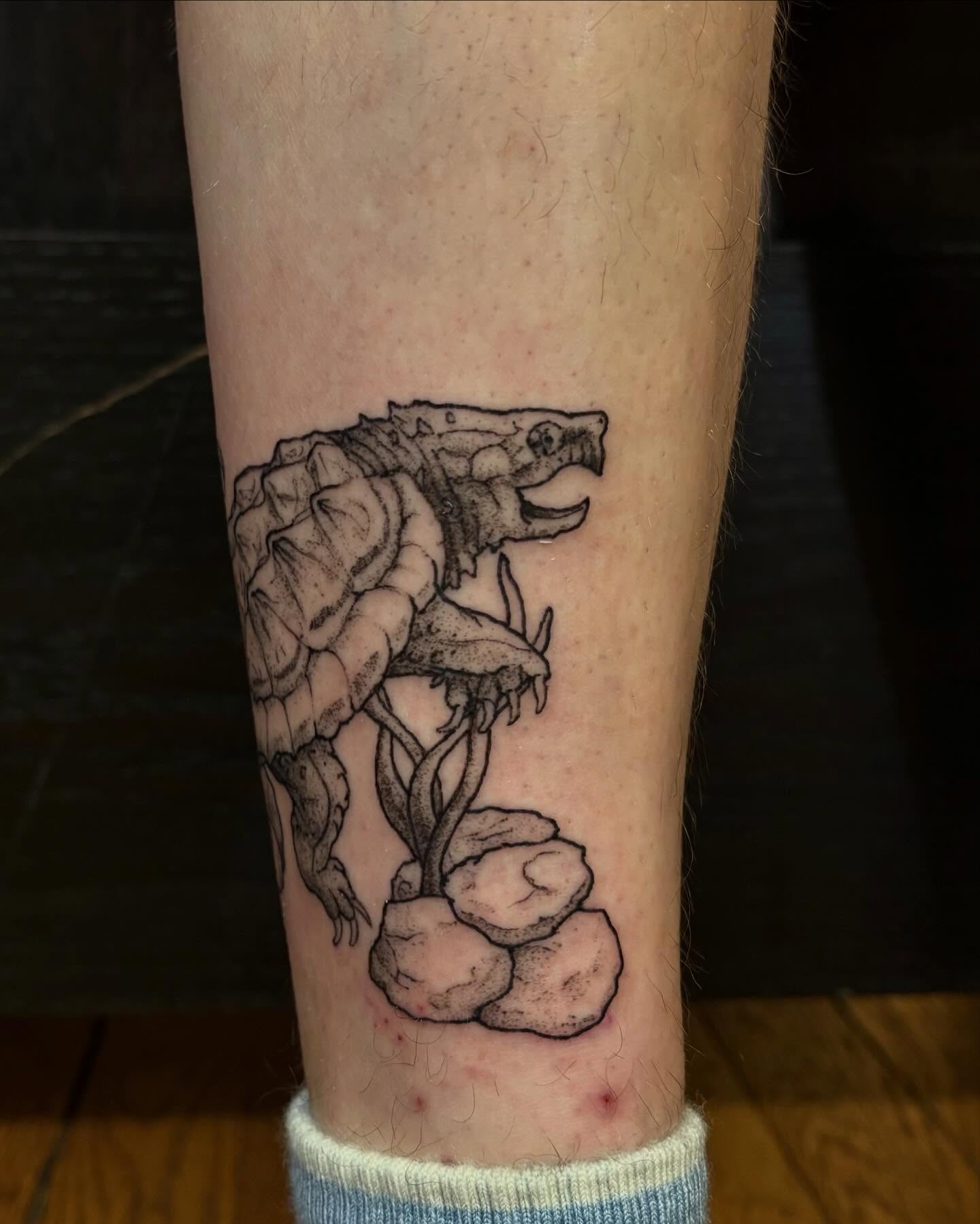 Turtle and flower black and grey tattoo on the forearm by kane
