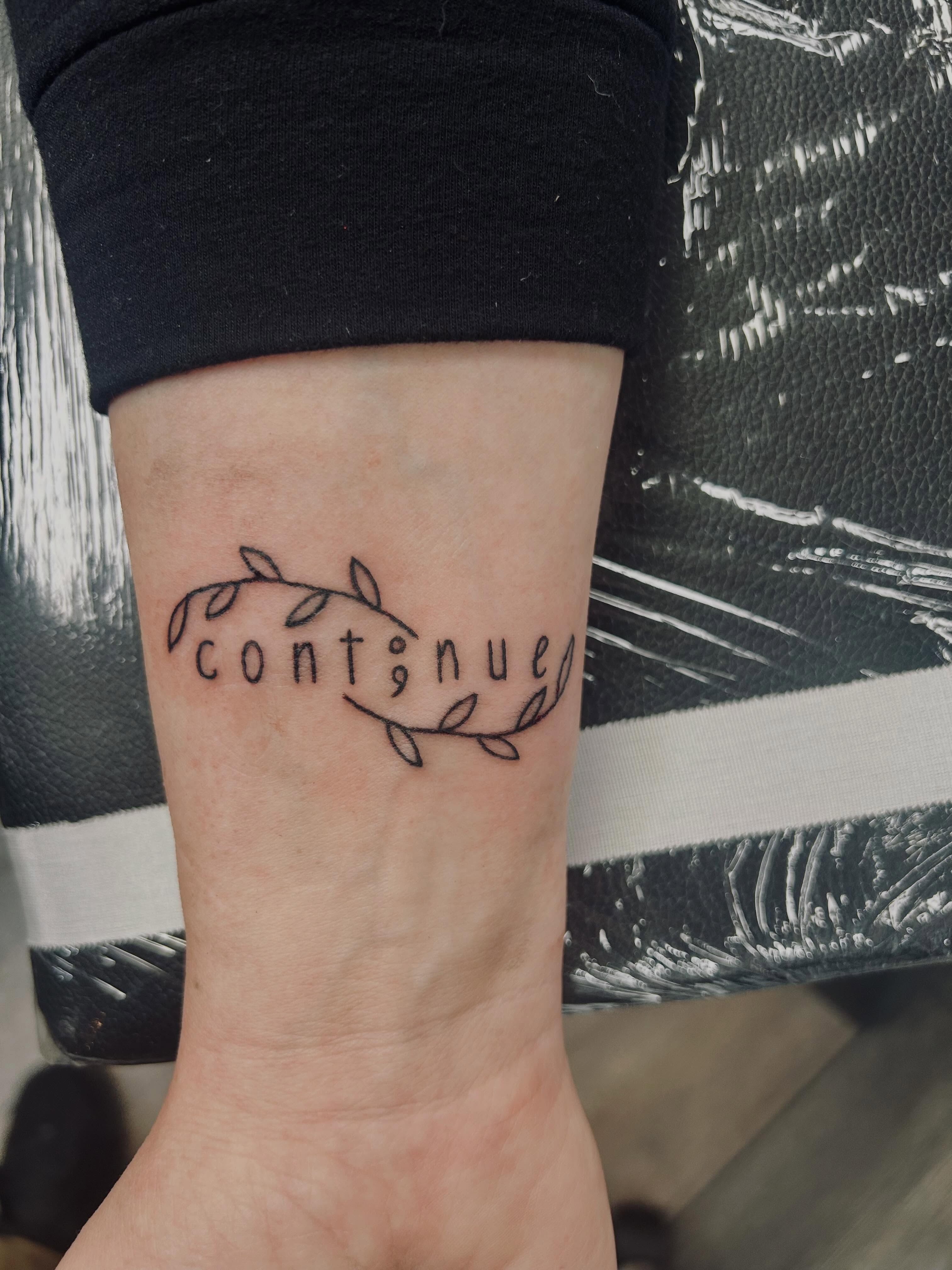 Continued lettering script tattoo on the forearm by Bjorn Bjornstad, Dubuque, Iowa