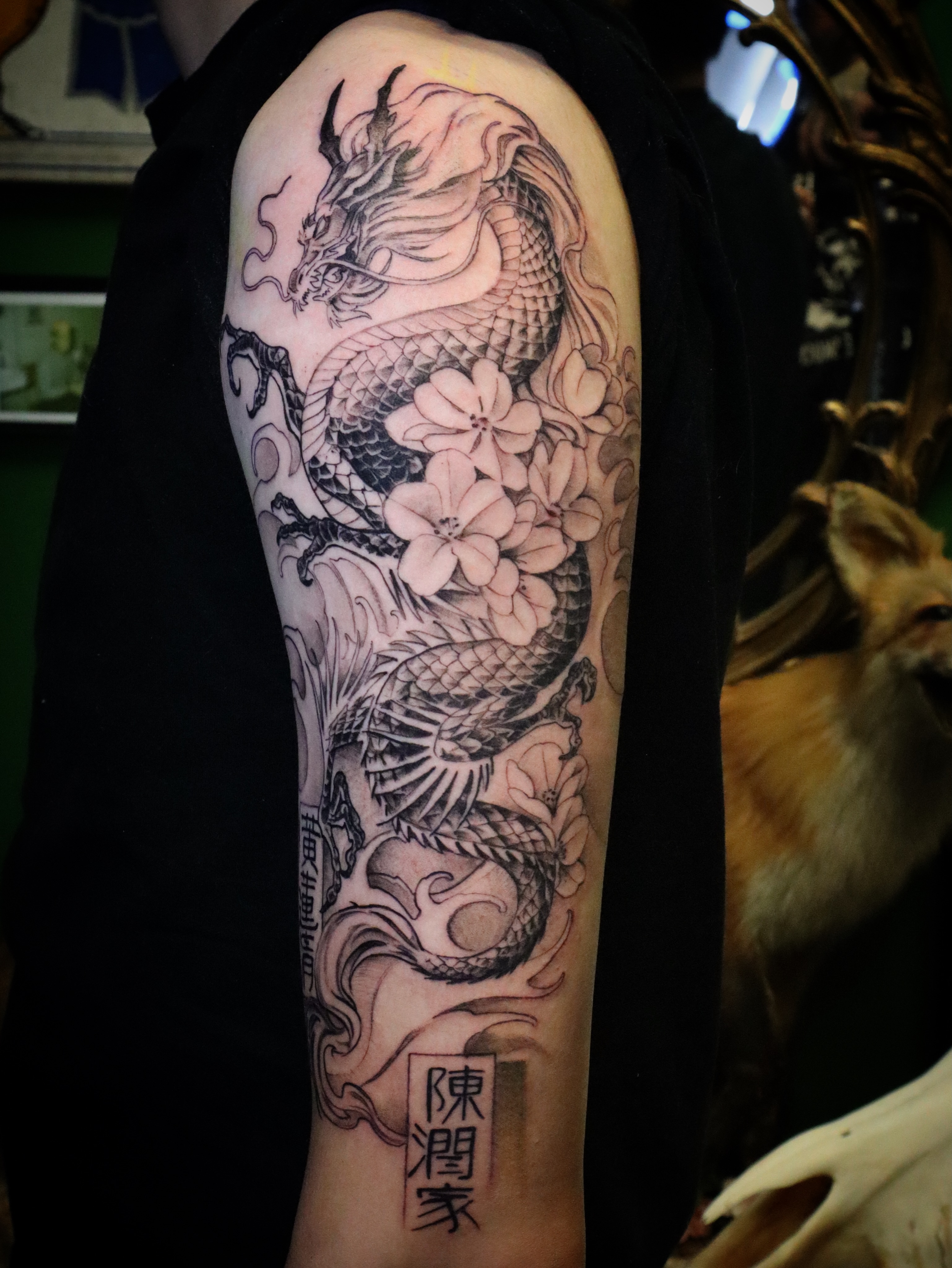 Dragon and cherry blossoms japanese irezumi tattoo on the forearm by Joe Hall