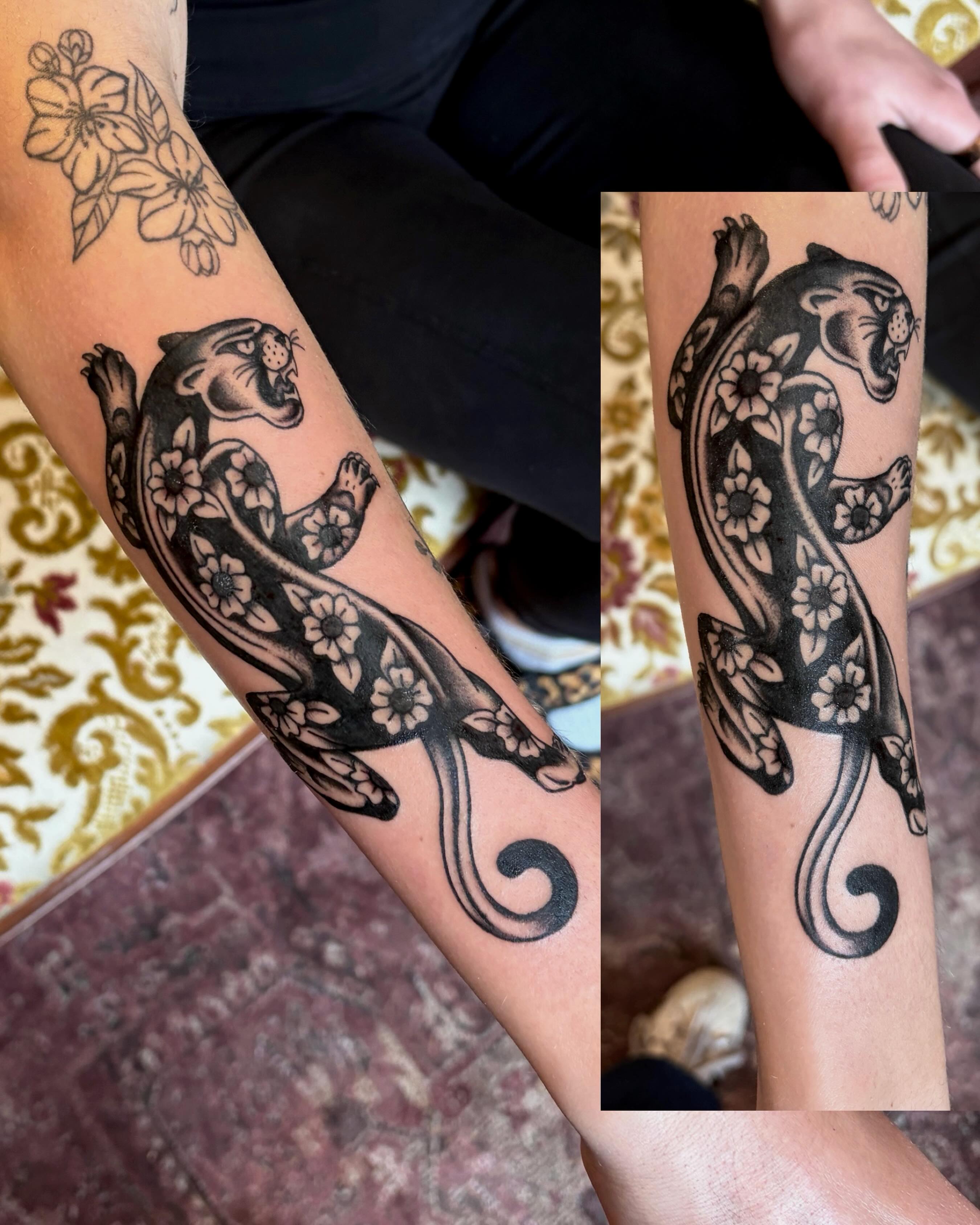 Panther and flowers black and grey tattoo on the forearm by Mary Hannah Sosdian