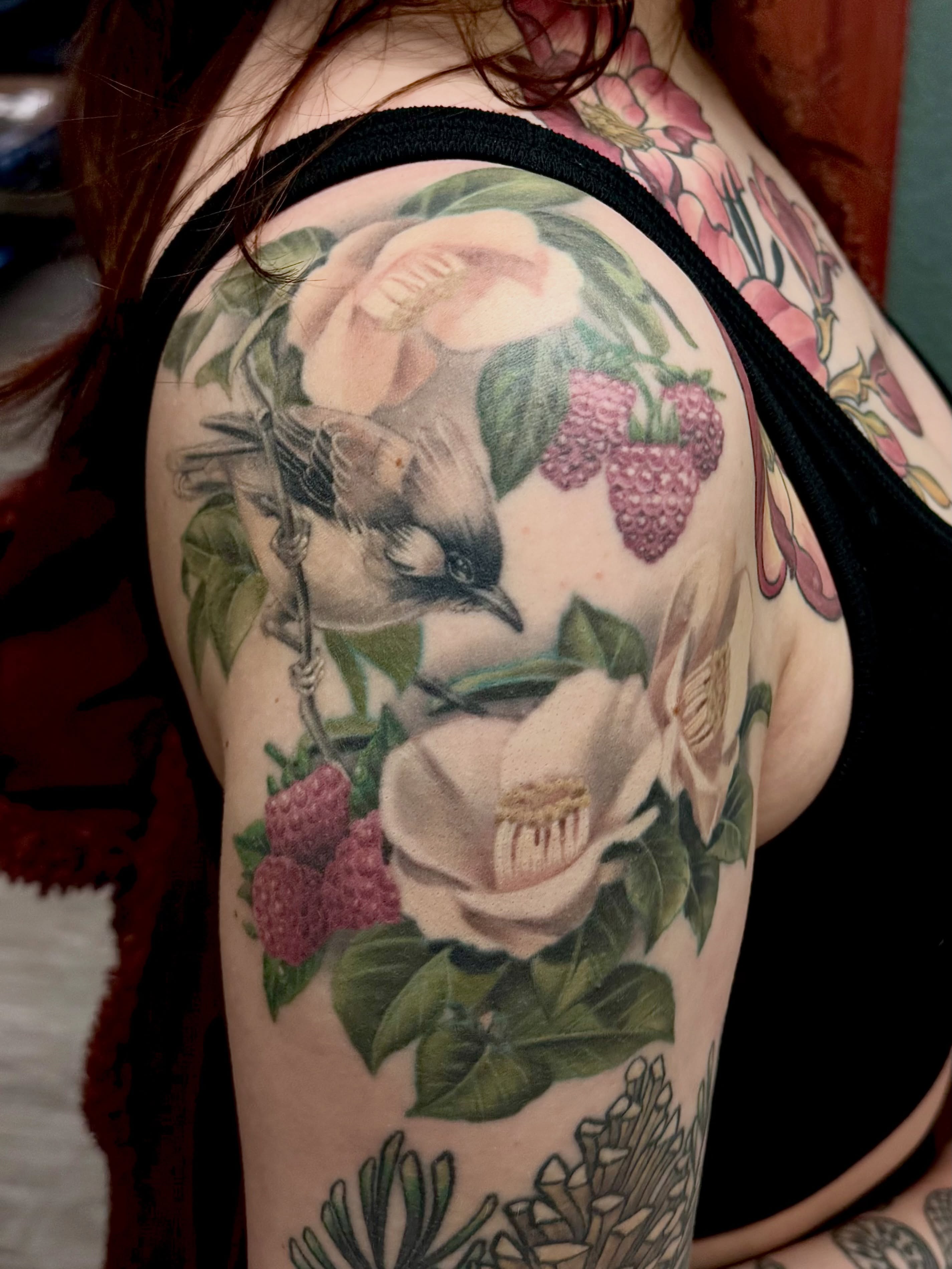 Bird and flowers realism tattoo on the shoulder by Emi Collison