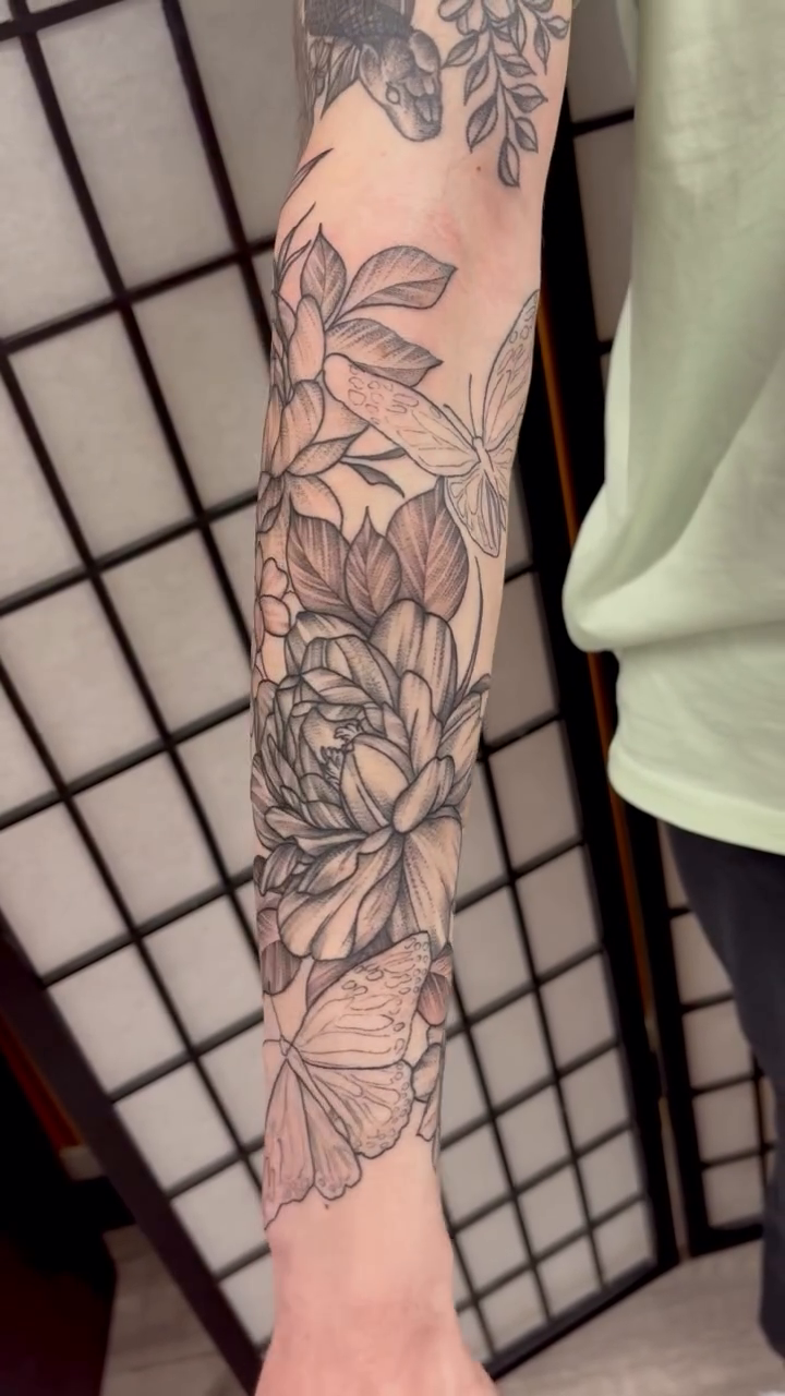 Floral sleeve with butterflies dotwork tattoo on the forearm by Krista Reid