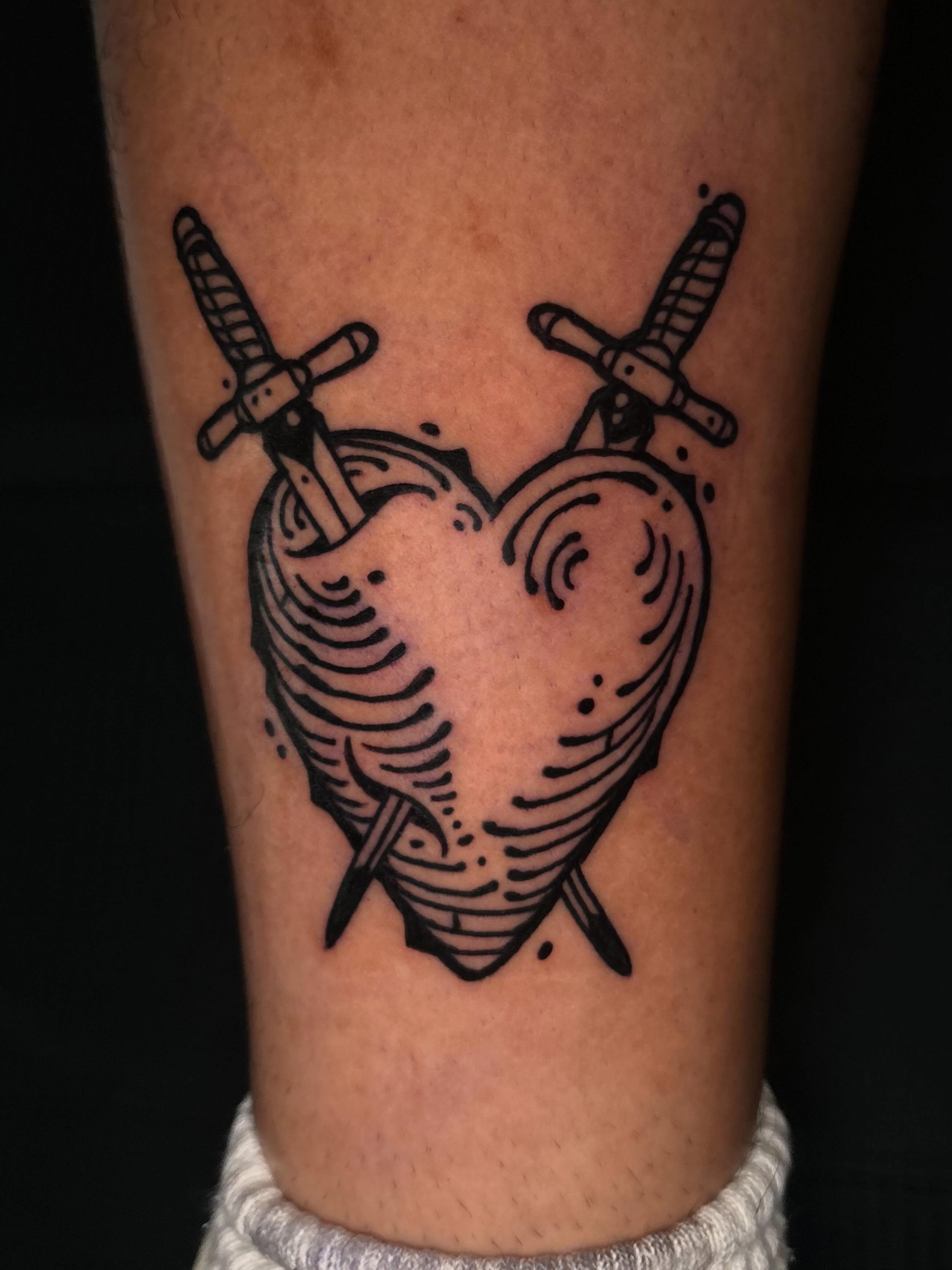 Heart with swords black and grey tattoo on the forearm by 𝕵𝖊𝖗𝖊𝖒𝖞 𝕻𝖚𝖗𝖈𝖊𝖑𝖑