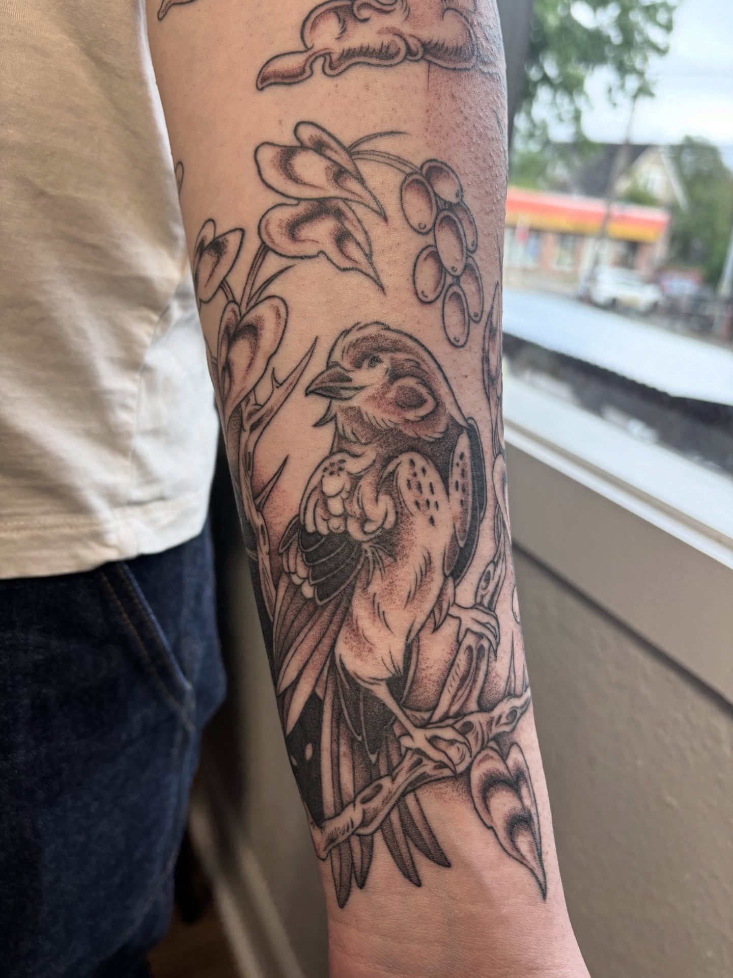 Bird and floral black and grey tattoo on the forearm by katie, Seattle, Washington
