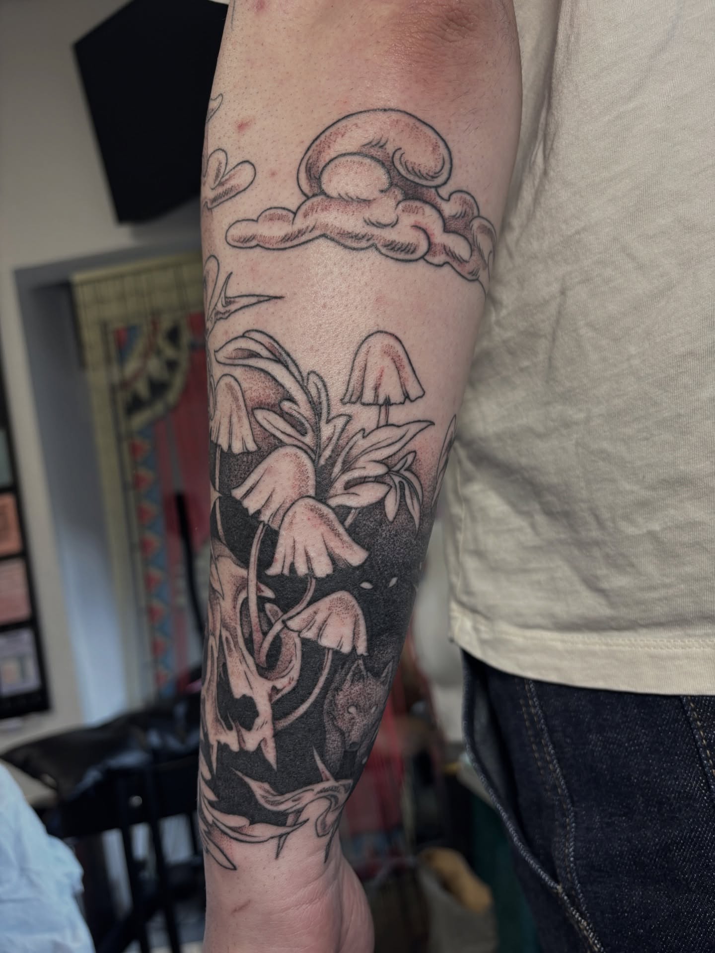 Mushrooms and clouds black and grey tattoo on the forearm by katie, Seattle, Washington