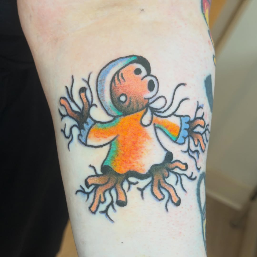 Child-like figure illustrative tattoo on the forearm by Gus Roach Graves