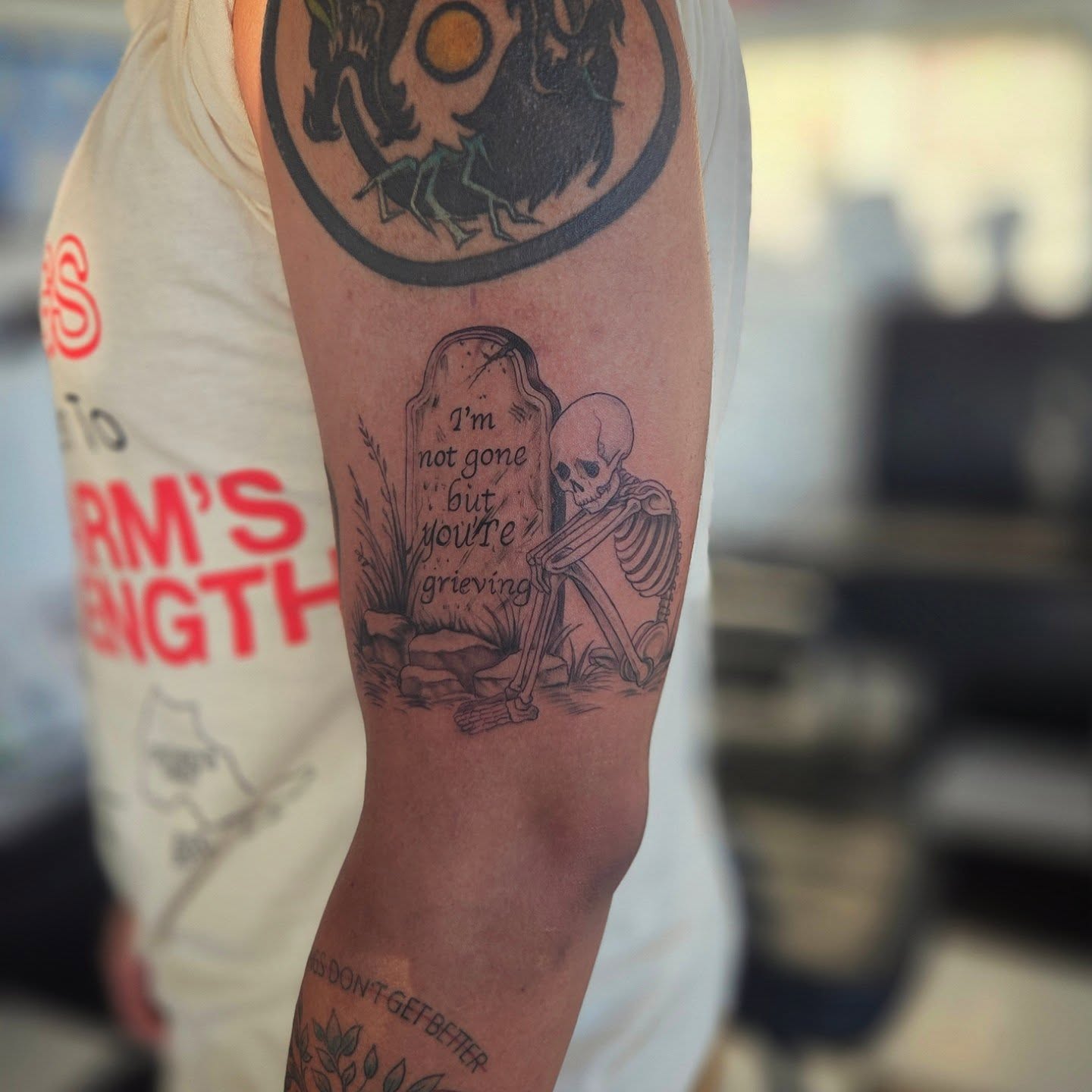 Skeleton with tombstone black and grey tattoo on the forearm by Molly DeSmedt