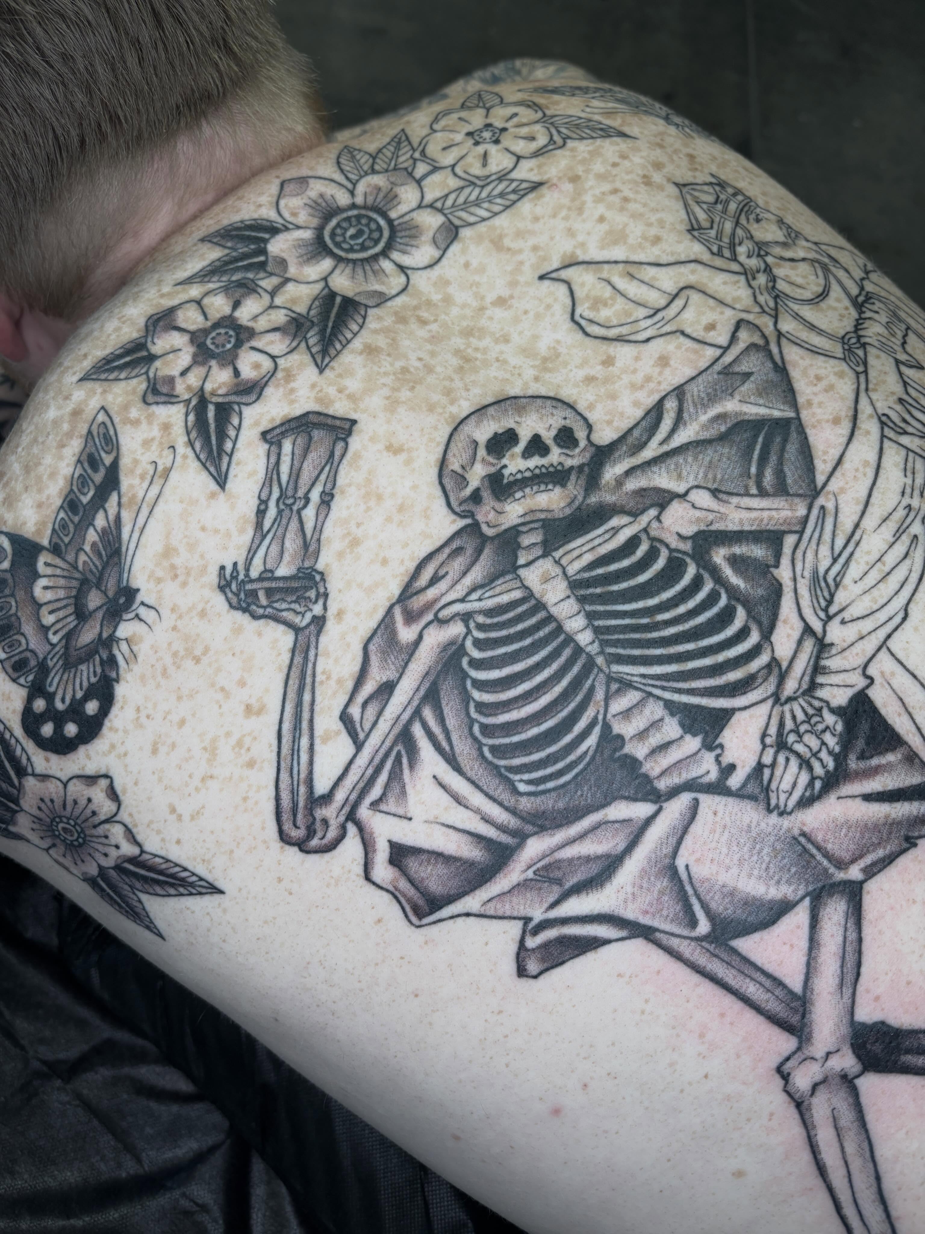 Skeleton with flowers black and grey tattoo on the thigh by Amelia Rose, Los Angeles, California